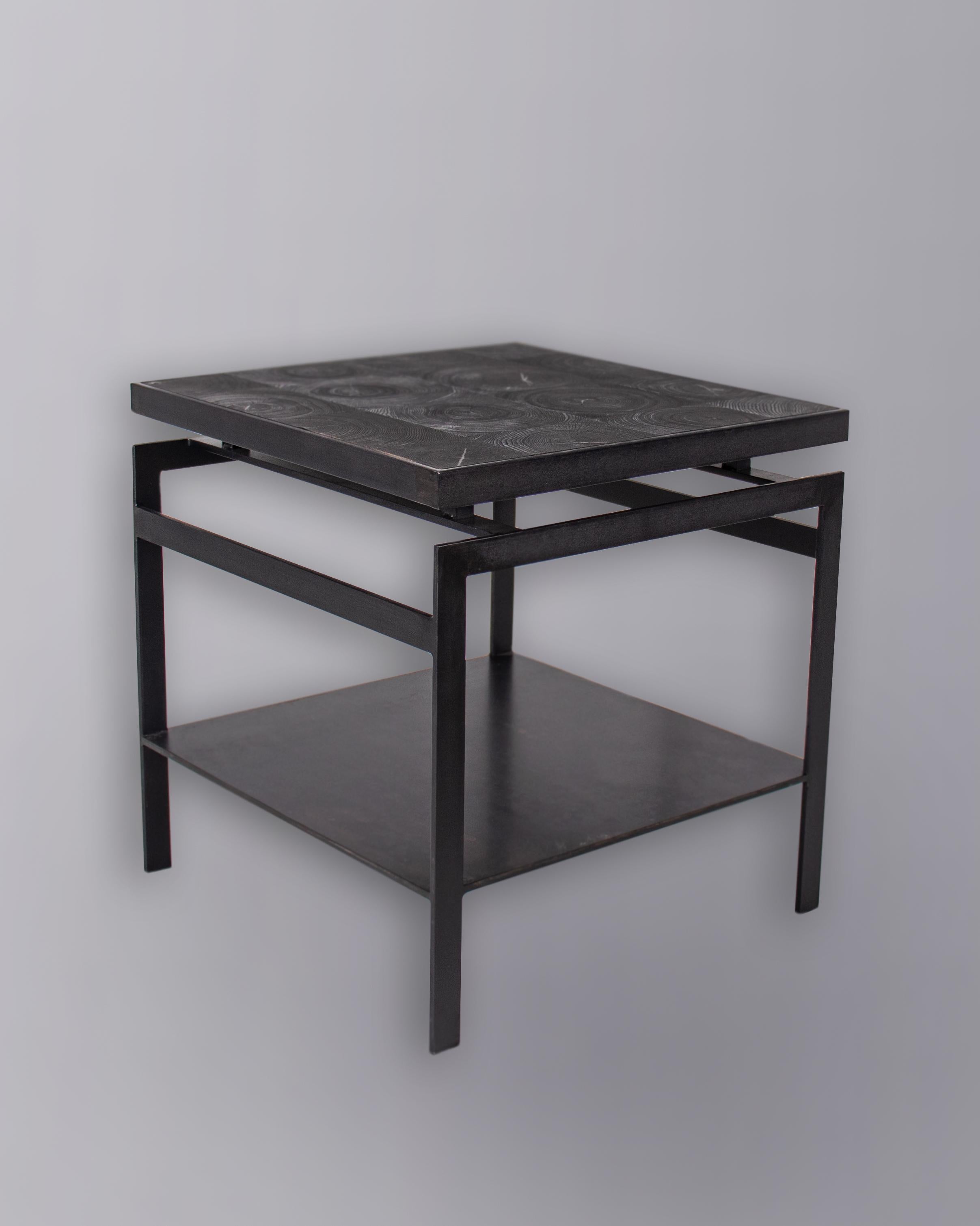 Minimalist end table made from solid black steel with ebonized black oak top.

Designed by Brendan Bass for the Vision and Design Collection, by using high quality materials and textures. All materials are sourced from local vendors throughout the