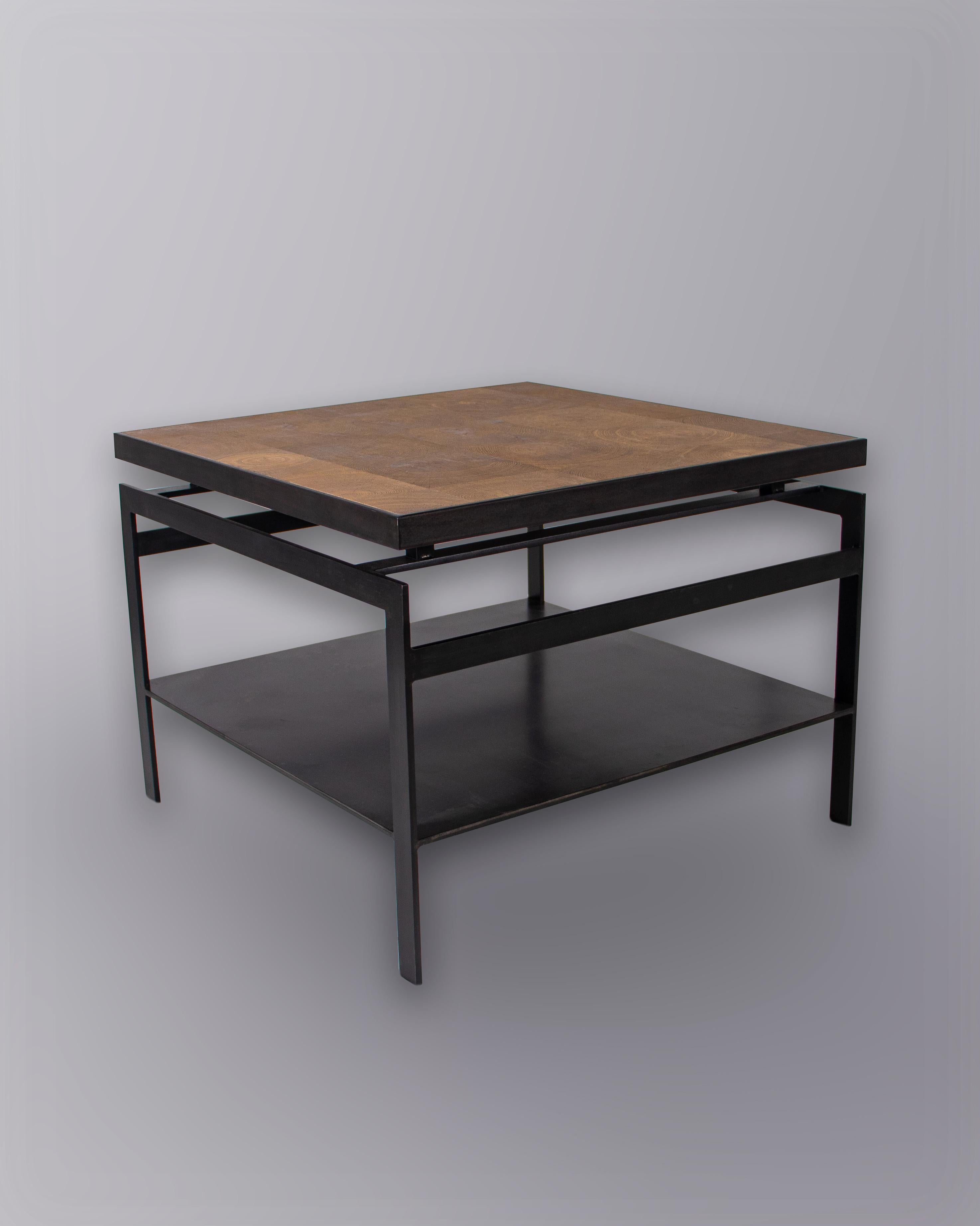 Minimalist end table made from solid black steel with natural oak top.