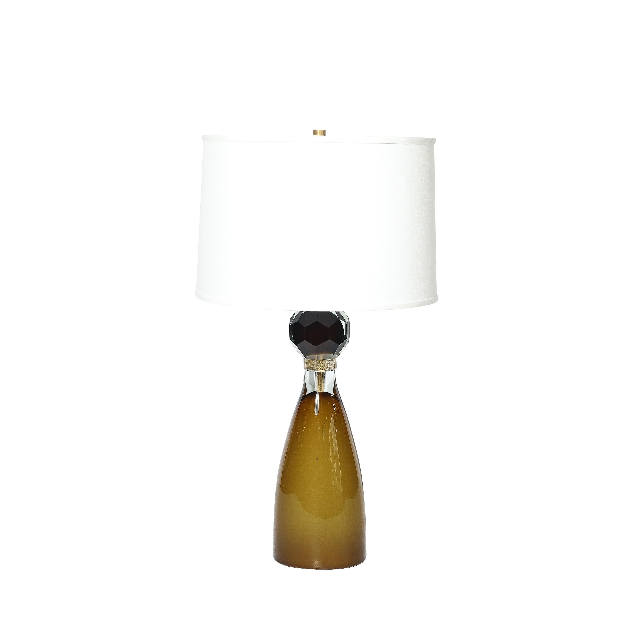 
A stunning pair of Modernist table lamps, crafted in Italy in the 21st century, showcasing the unparalleled artistry and technical mastery of Murano glassmakers. These lamps feature hand-blown Murano glass in an elegant hourglass form, designed to