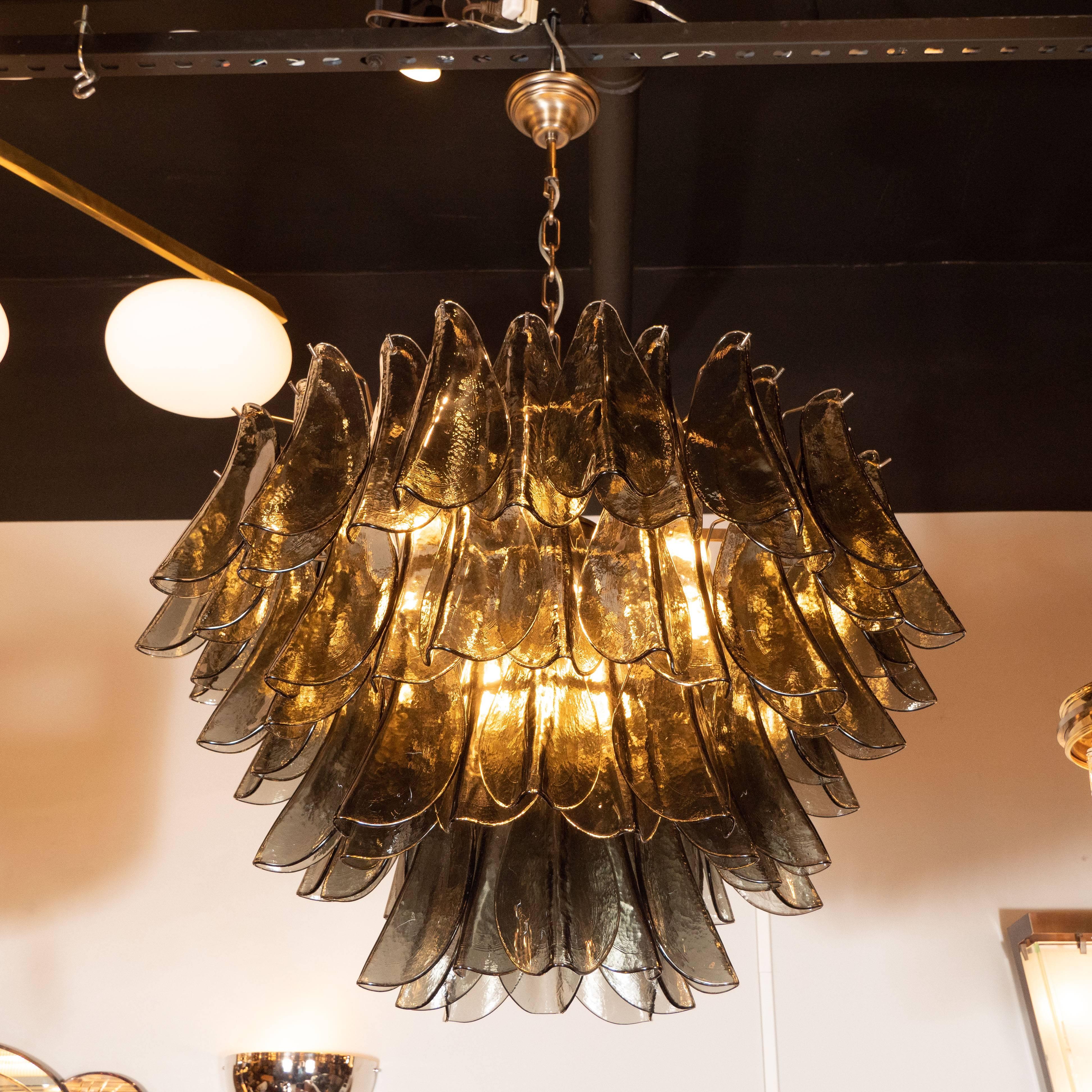 This refined and sophisticated chandelier was realized in Murano, Italy- the islands off the coast of Venice renowned for centuries for their superlative quality glass production. It offers an abundance of handblown Murano glass shades in a smoked