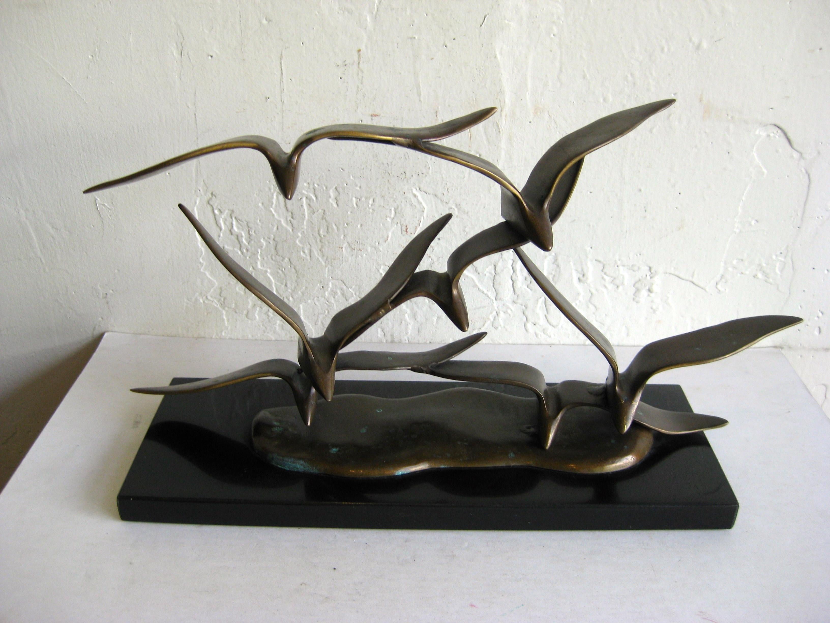 Modernist bronze flock of seagulls in flight sculpture mounted onto a marble base. I can not find any artist signatures or marks. Made very well and was high quality piece. Form and design are wonderful. The bronze has a nice patina and was hand