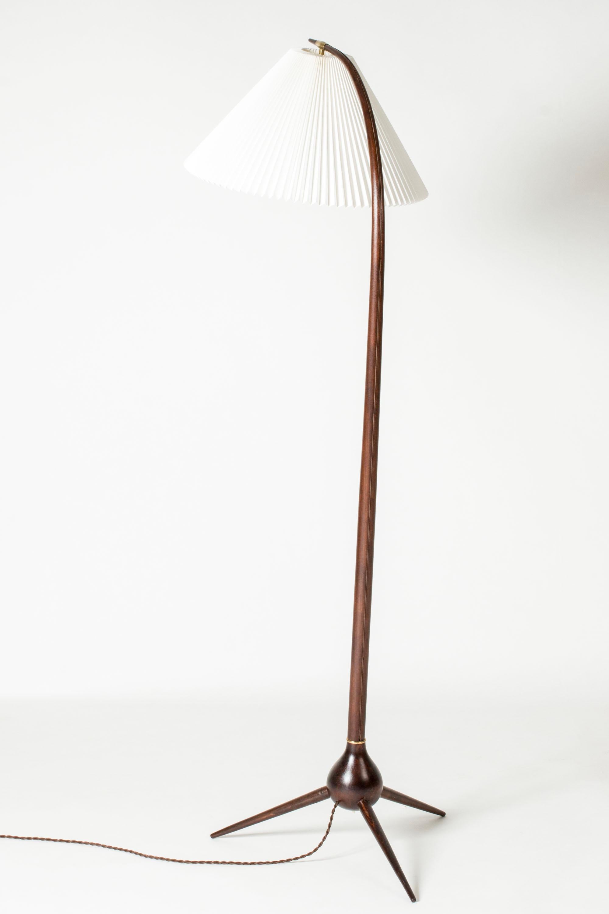 Striking”Bridge” floor lamp by Severin Hansen. The stem is made from stained beech bent into an elegant curve, with the cord visible running along the back. Three feet in an onion-shaped joint with a brass detail. Beautiful, organic design, Le Klint