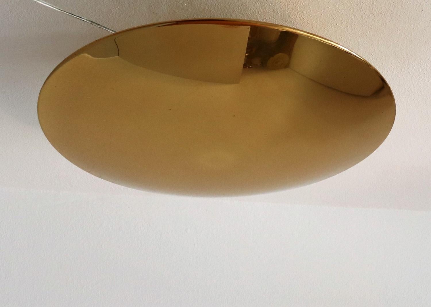 Beautiful and big ceiling light or wall sconce made of full brass by Florian Schulz in the 1980s.
The large round dome plate is screwed on the wall or ceiling unit, which holds five Edison light bulbs.
The brass has taken over the years a