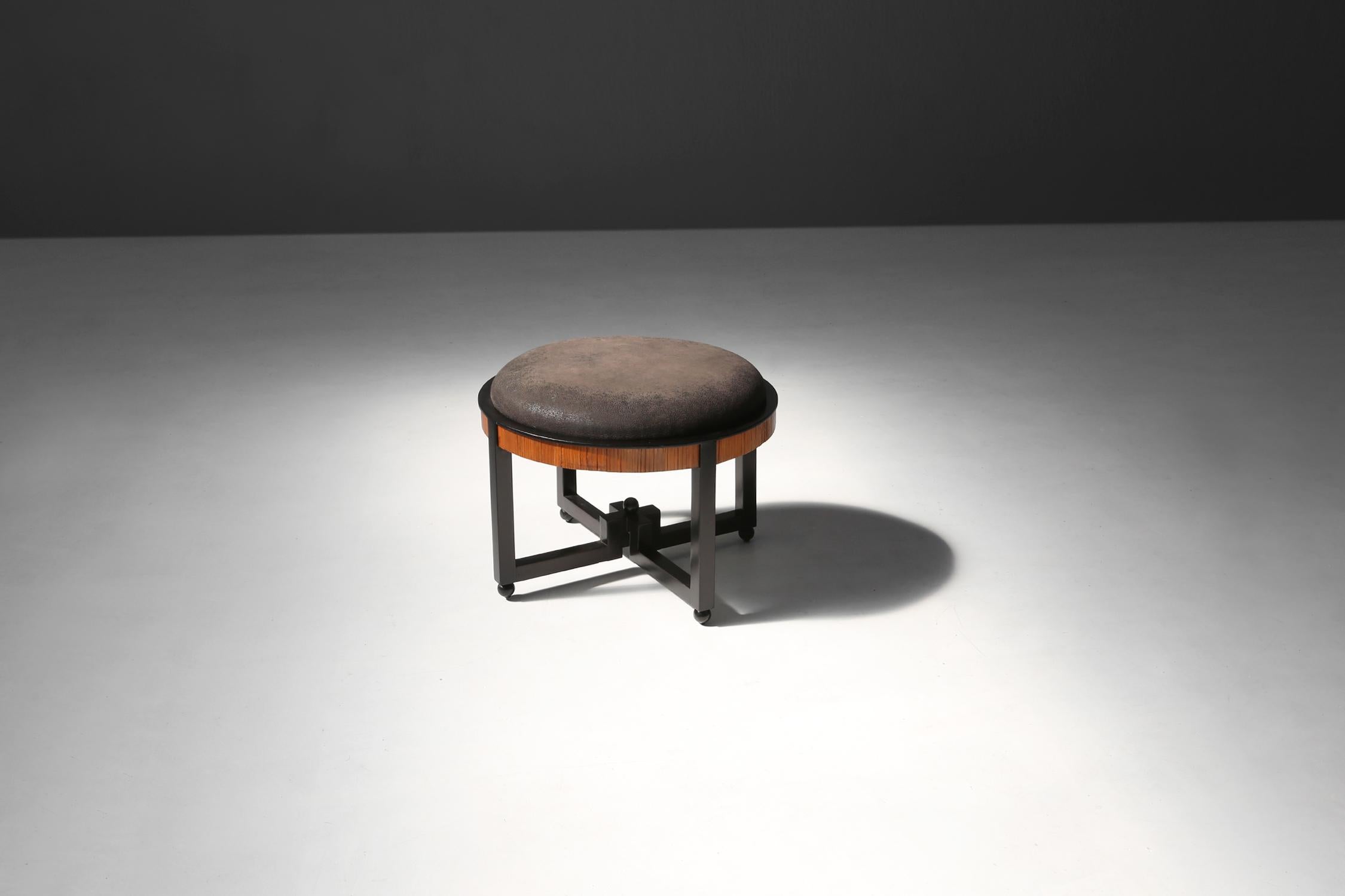 This 1920s footstool was designed in the spirit of Huib Hoste, a pioneer of Belgian avant-garde architecture and furniture art. He was one of the founders of the avant-garde movement in Belgium.

The base of the footstool is made of wood and