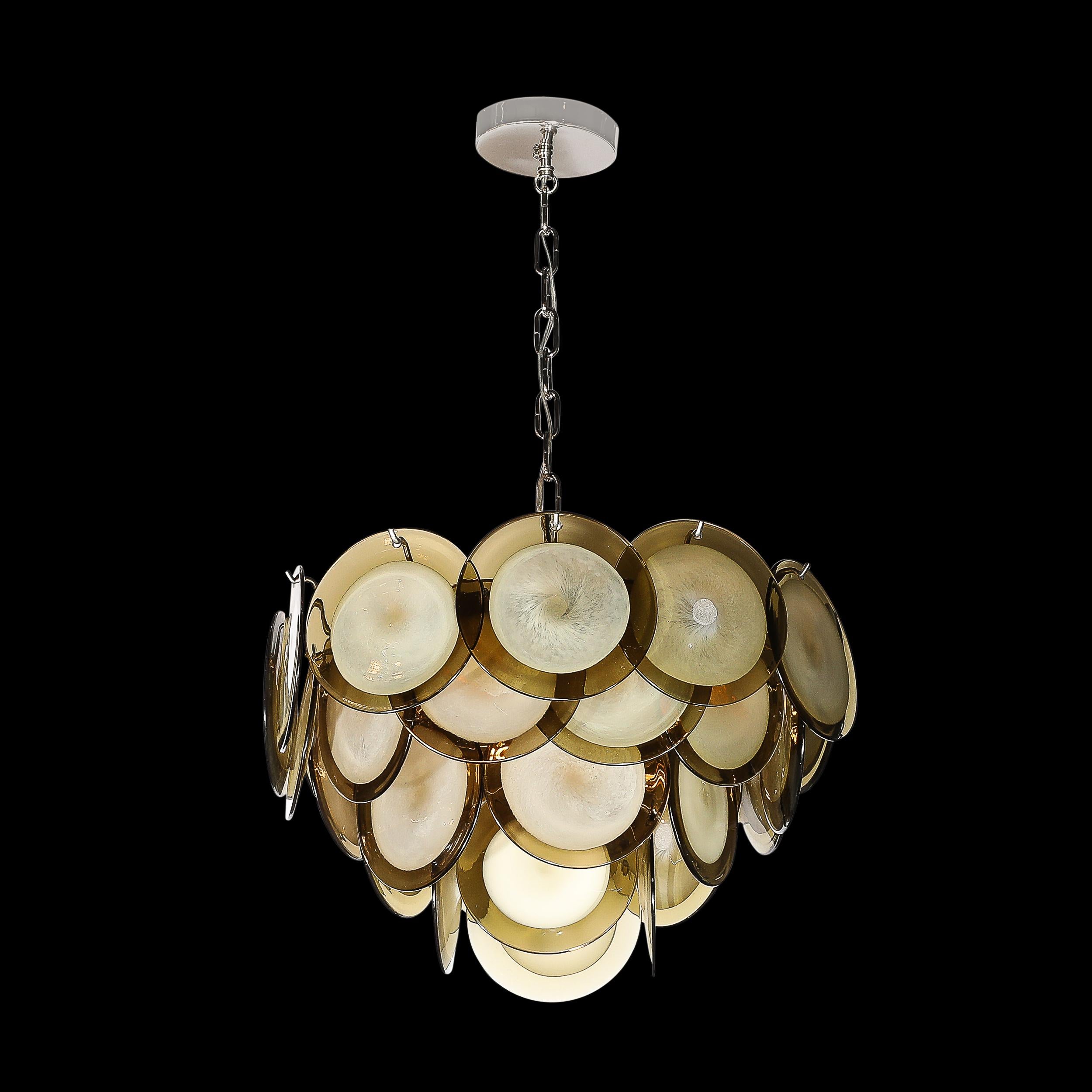 This refined modernist chandelier was realized in Murano, Italy- the island off the coast of Venice renowned for centuries for its superlative glass production. It features a conical body composed of a wealth of handblown Murano circular shades with