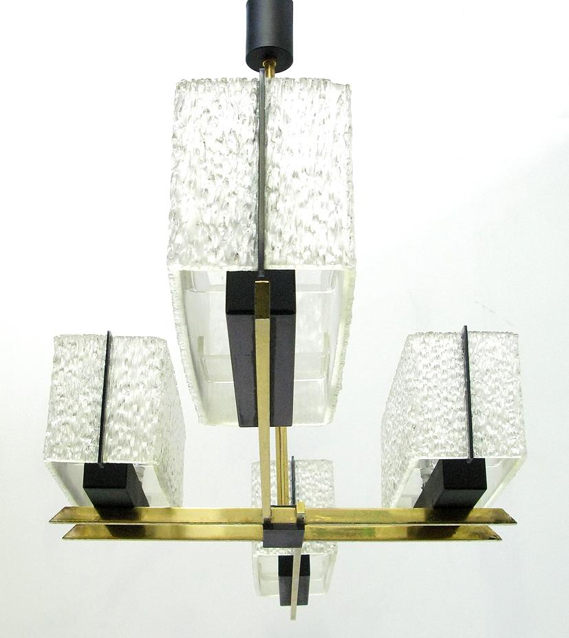 A large, geometric 1960s chandelier by French makers Maison Arlus.

The same chandelier is featured in the Madmen meeting room.

In brass and steel with Lucite and perspex shades, the angular form would perfectly suit a hallway or rectangular