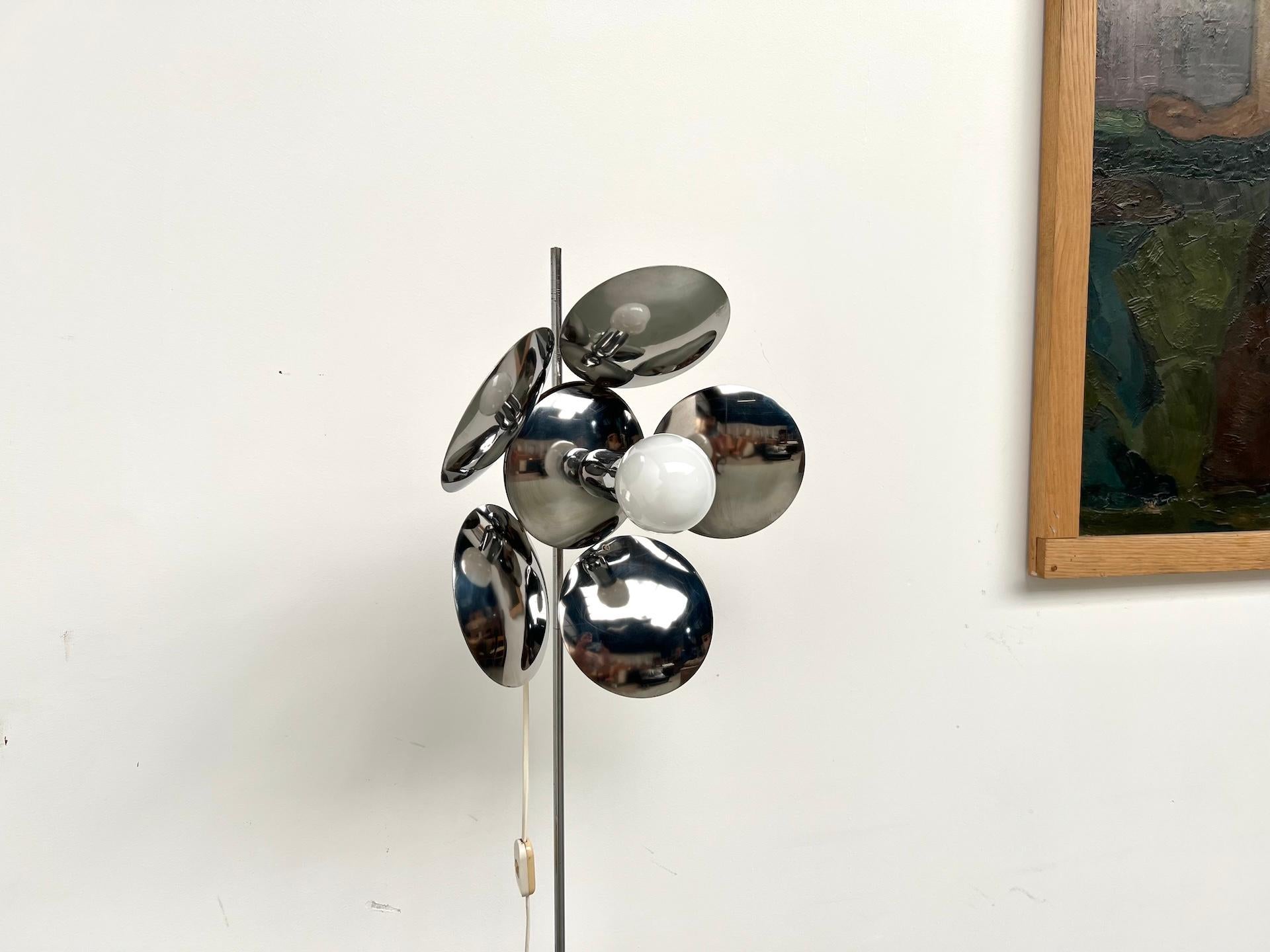 Maison Lecan presents this beautiful modernist floor lamp from the 1970s, distinguished by its refined flower-shaped silhouette. Made of a slender white lacquered metal stem, it features a cluster of chrome spheres arranged like a flower around a