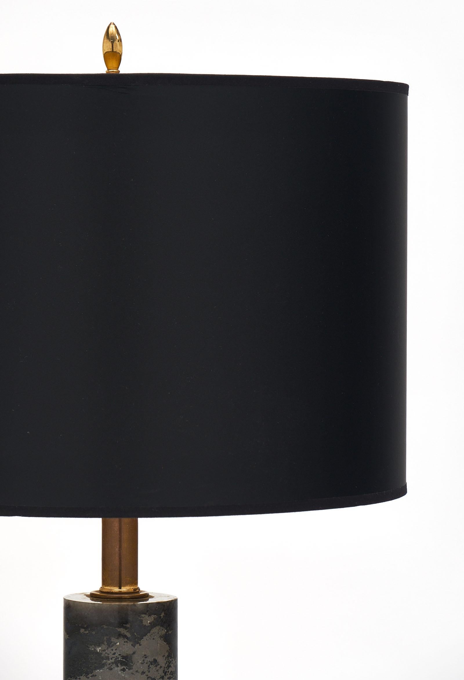 French modernist marble table lamps with a Turquin marble cylinder supported by an ebonized wooden base. The brass hardware adds to the elegance of this piece. It has been newly wired to fit US standards.
