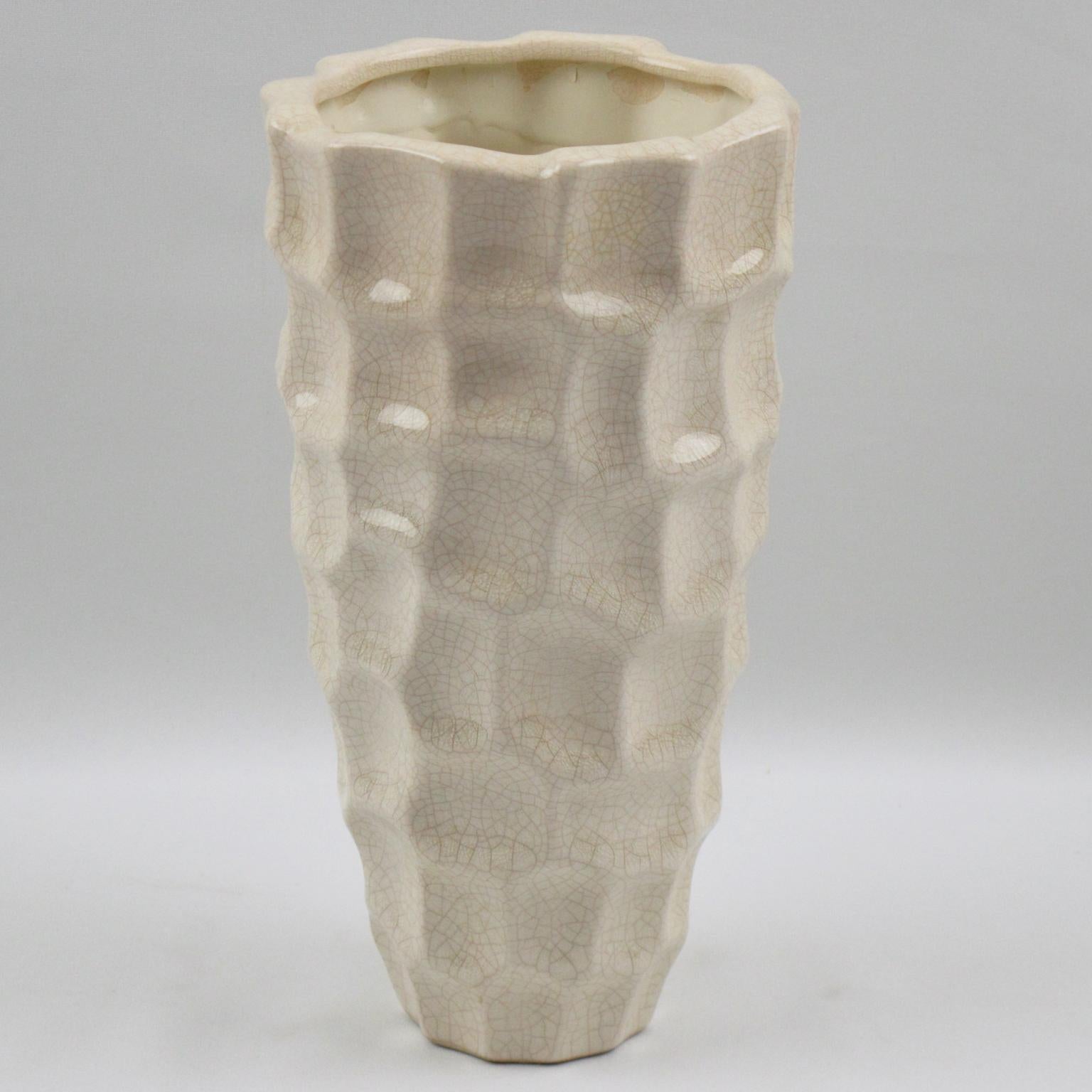 Nice Art Deco vase by Saint Clement, France. Ceramic vase with white crackle glaze finish, features a tumbler shape with large opening and stunning modernist carved design.
The crackle clear glaze was a popular technique for animal and figural