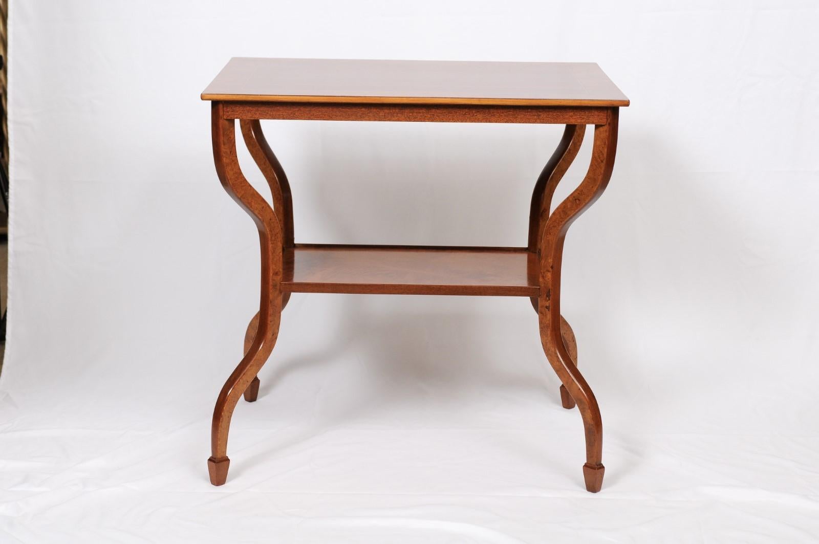 Modernist French-style wood side or end tables. An overhanging top above a lower shelf with inverted cabriole legs. Dimensions: H 28 inches, W 20.5 inches, D 28.5 inches.