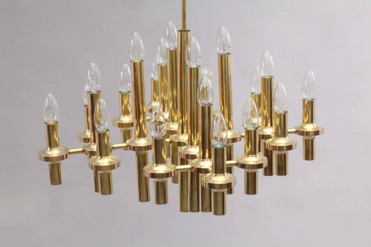 Brass chandelier,
Designed by Gaetano Sciolari,
Italy, 1970.
18 bulb sockets E 14.
The length of the stem can be altered to any size for free
