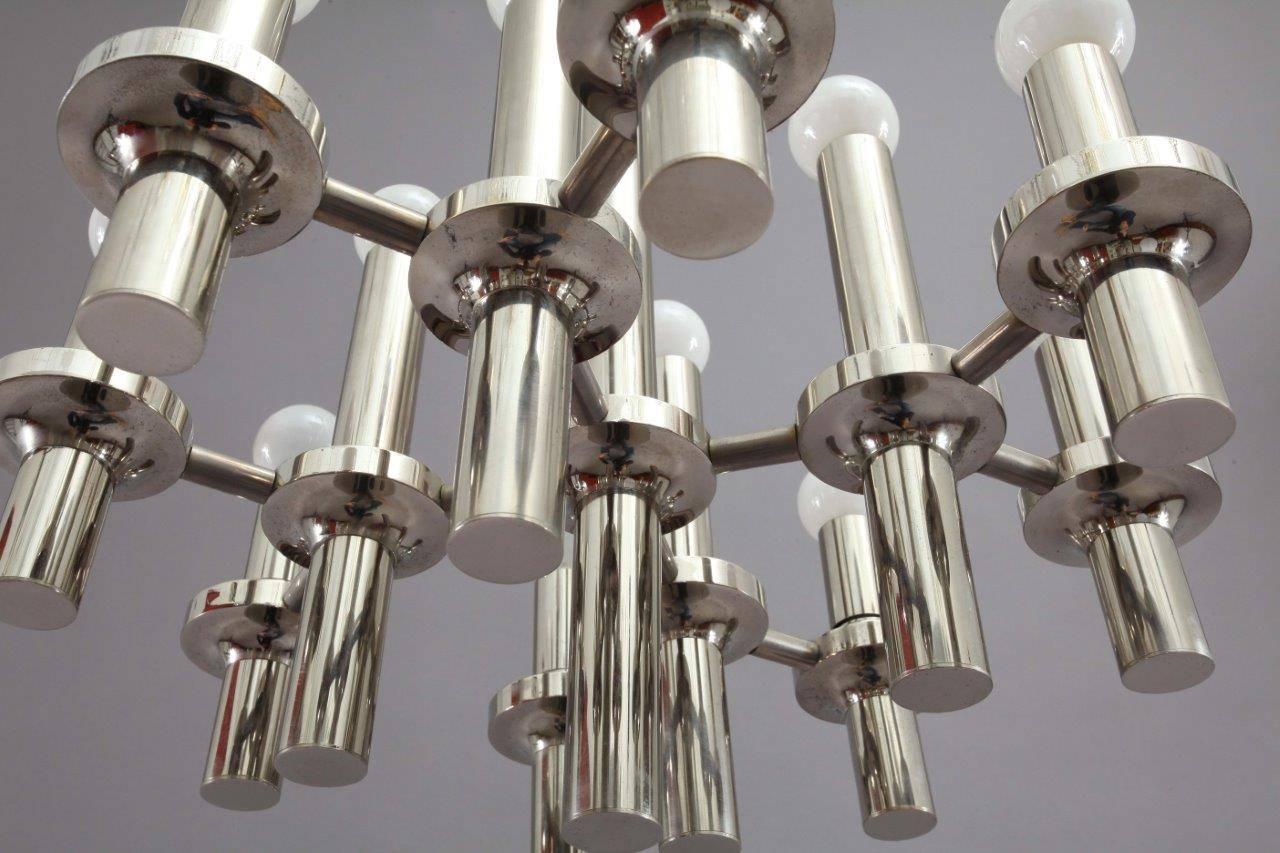 Chrome chandelier,
Designed by Gaetano Sciolari,
Italy, 1970.
16 bulb sockets E 14.
The length of the stem can be altered to any size for free