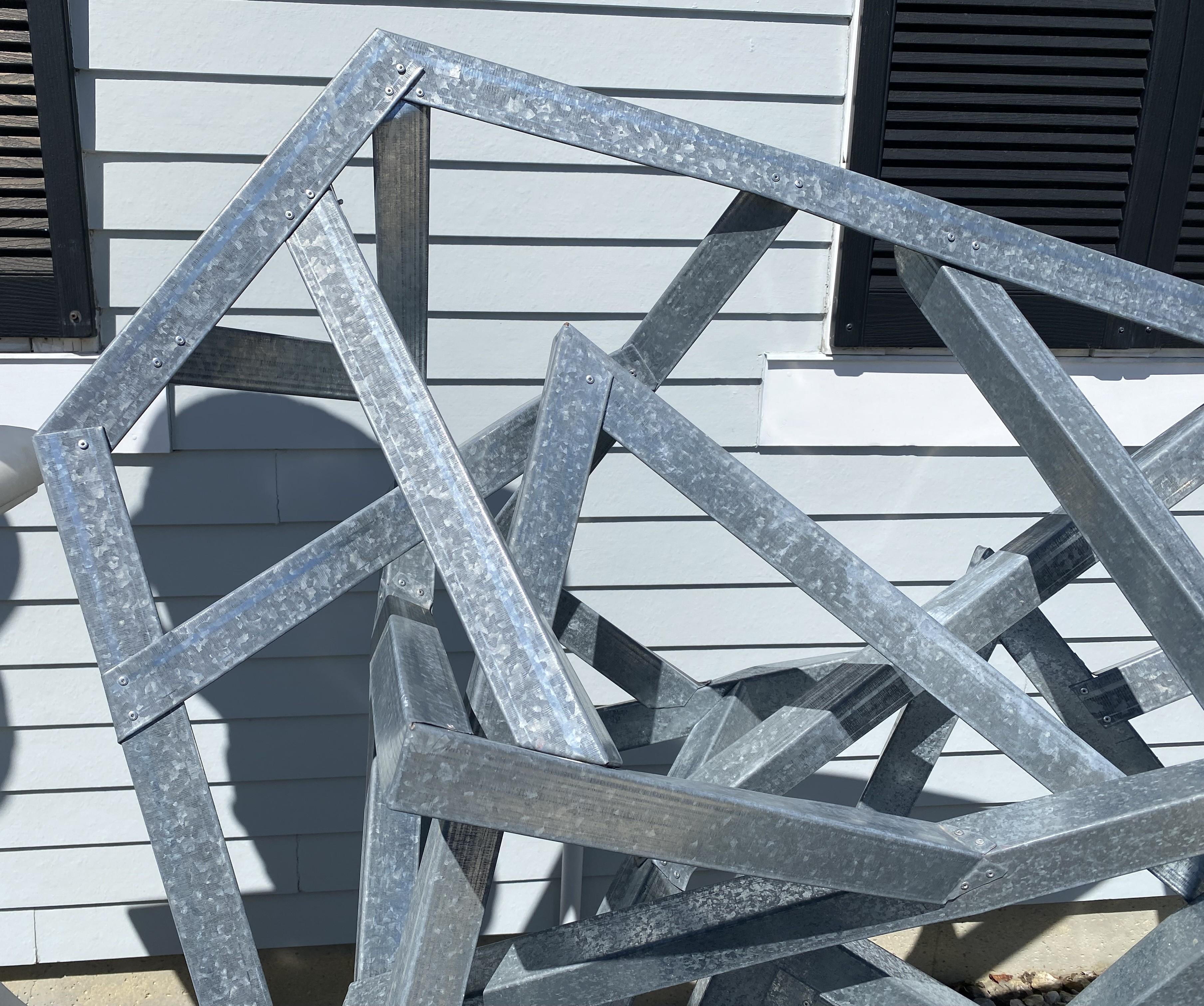 A fine modernist geometric lightweight galvanized metal sculpture, possibly aluminum, riveted construction, unsigned. Dates to the 20th century in very good condition, with some minor bends on a few of the base support pieces. A great accent piece