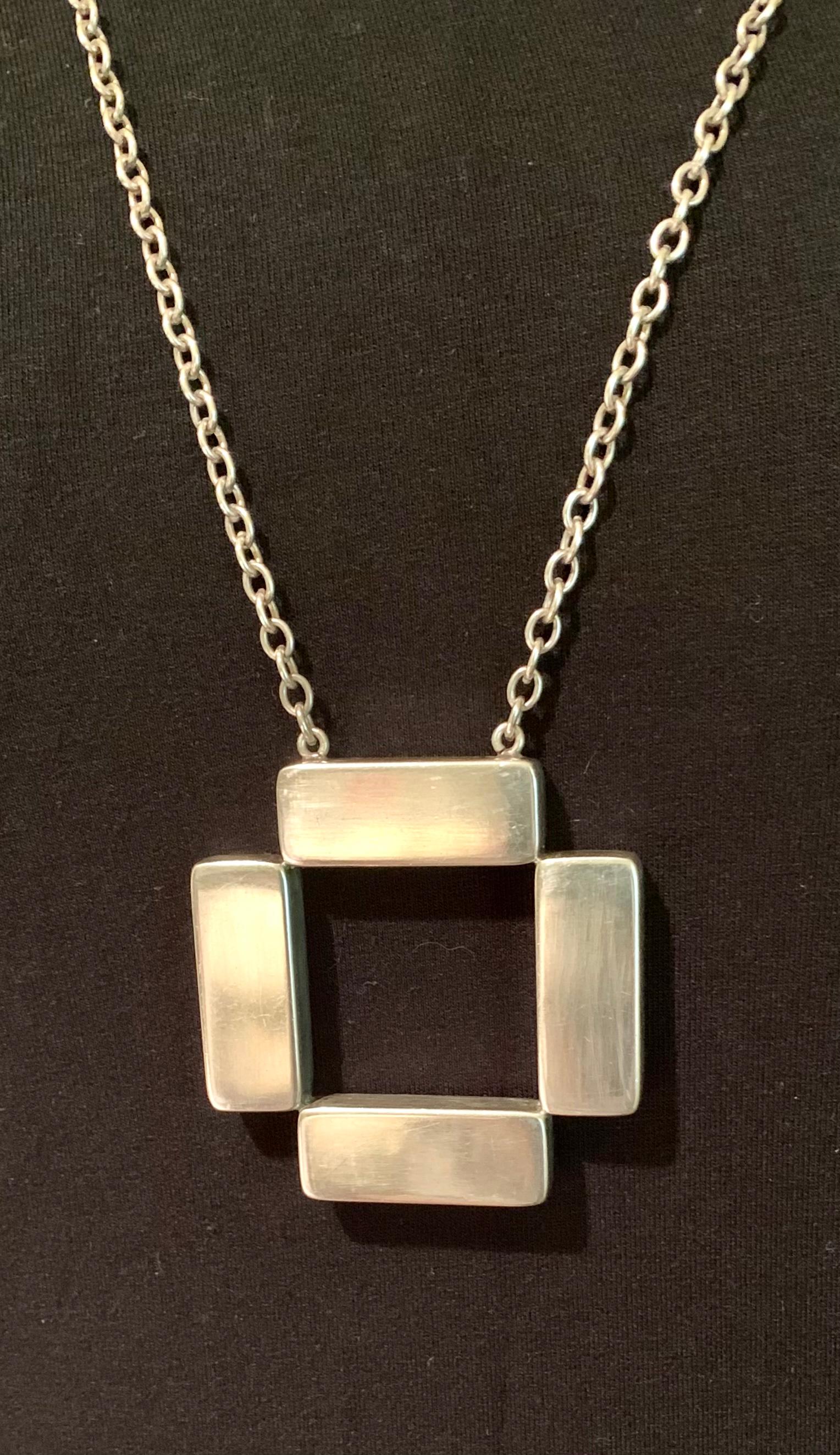 Scarce large 1970's Scandinavian Modernist sterling silver cross bars necklace by Astrid Fog for Georg Jensen.
Astrid Fog (1911-1993) designed her first jewelry collection for Georg Jensen in 1969. Her jewelry designs are distinctive for their large
