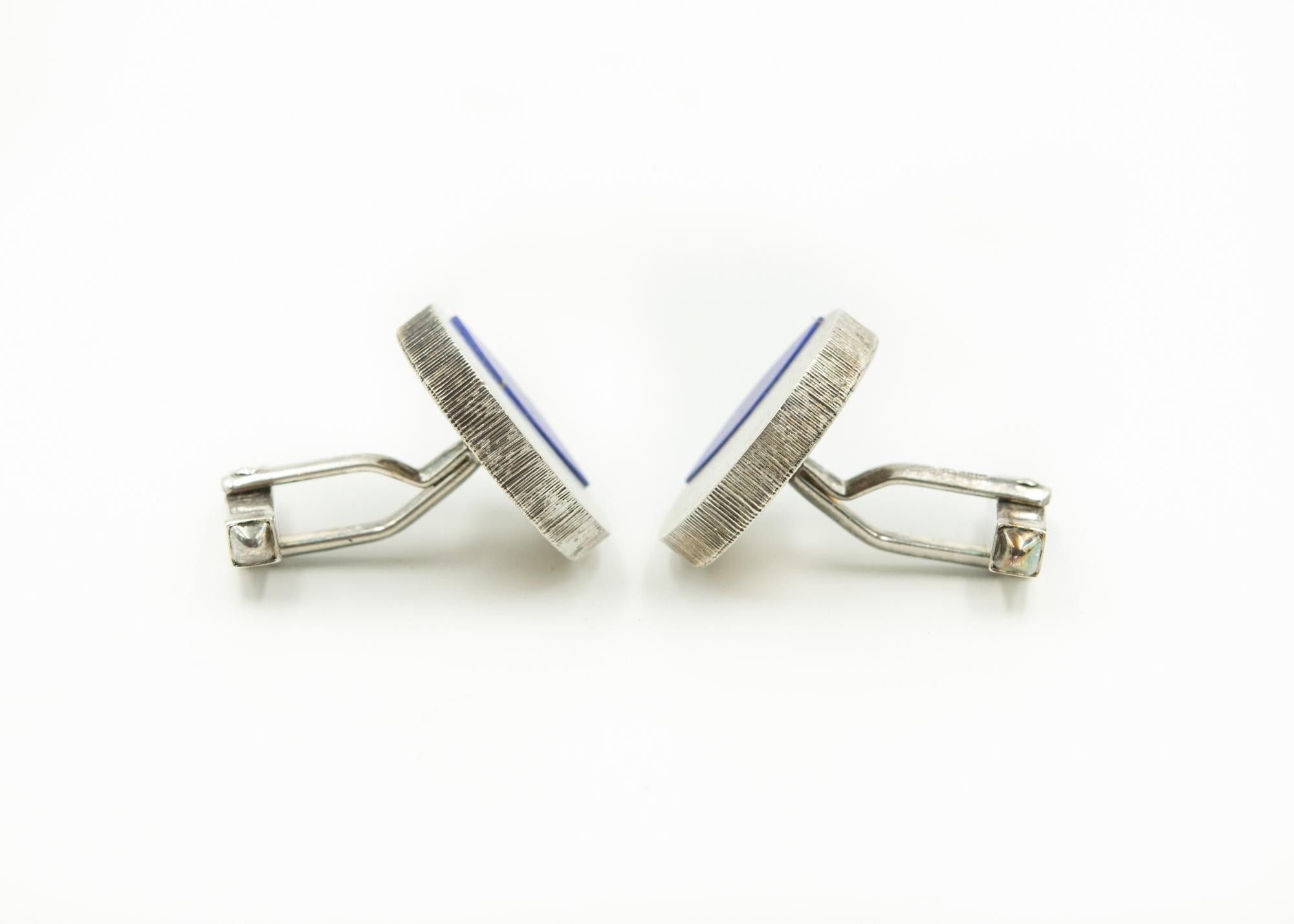 Modernist German sterling silver round cufflinks featuring inlaid lapis lazuli set in a matte finished sterling circle.  The backs are bullet backs.

On the backs they are marked sterling & Germany.