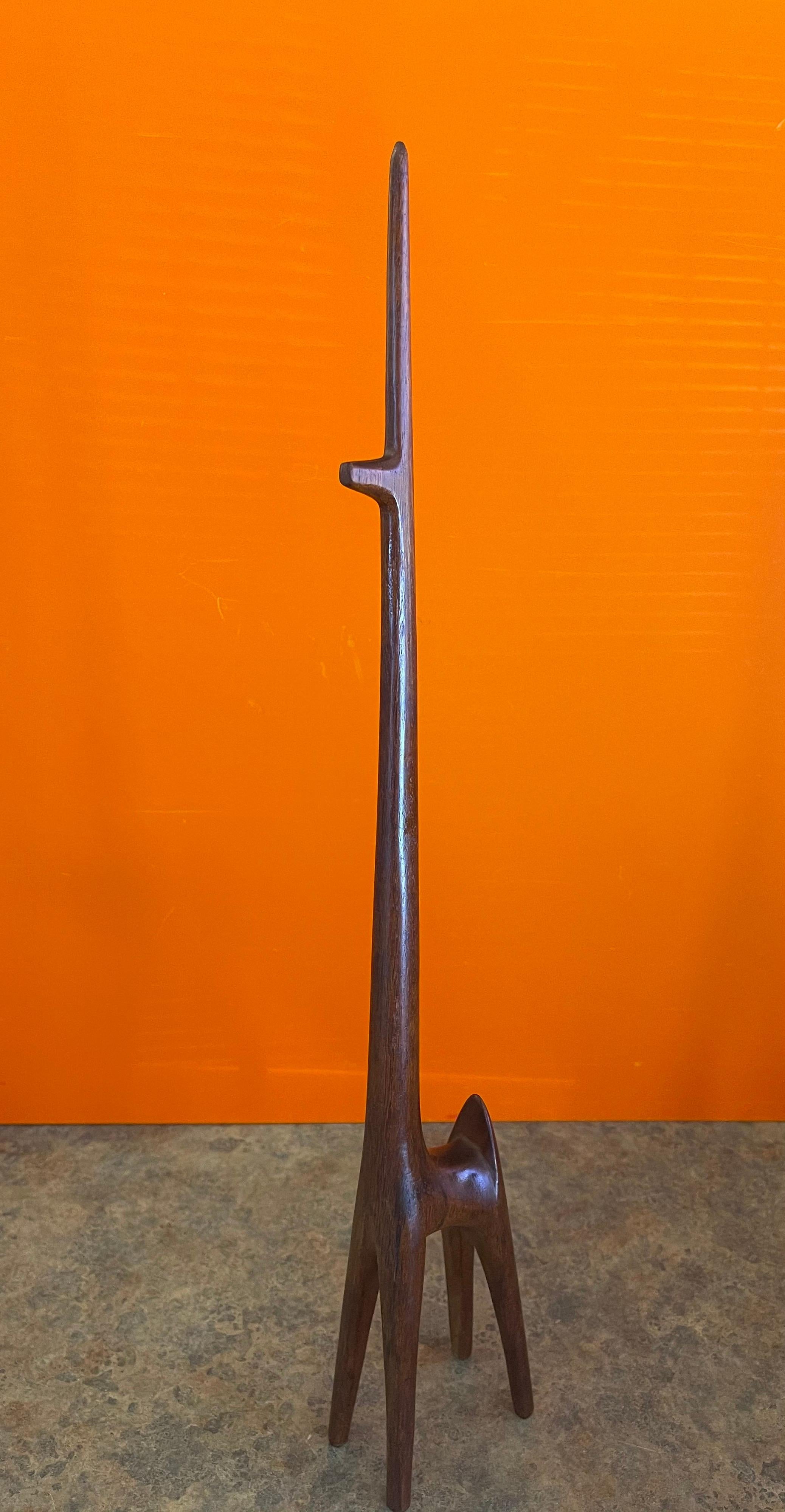 Super cool modernist giraffe sculpture in walnut, circa 1960s. The piece is hand carved from walnut and measures: 4