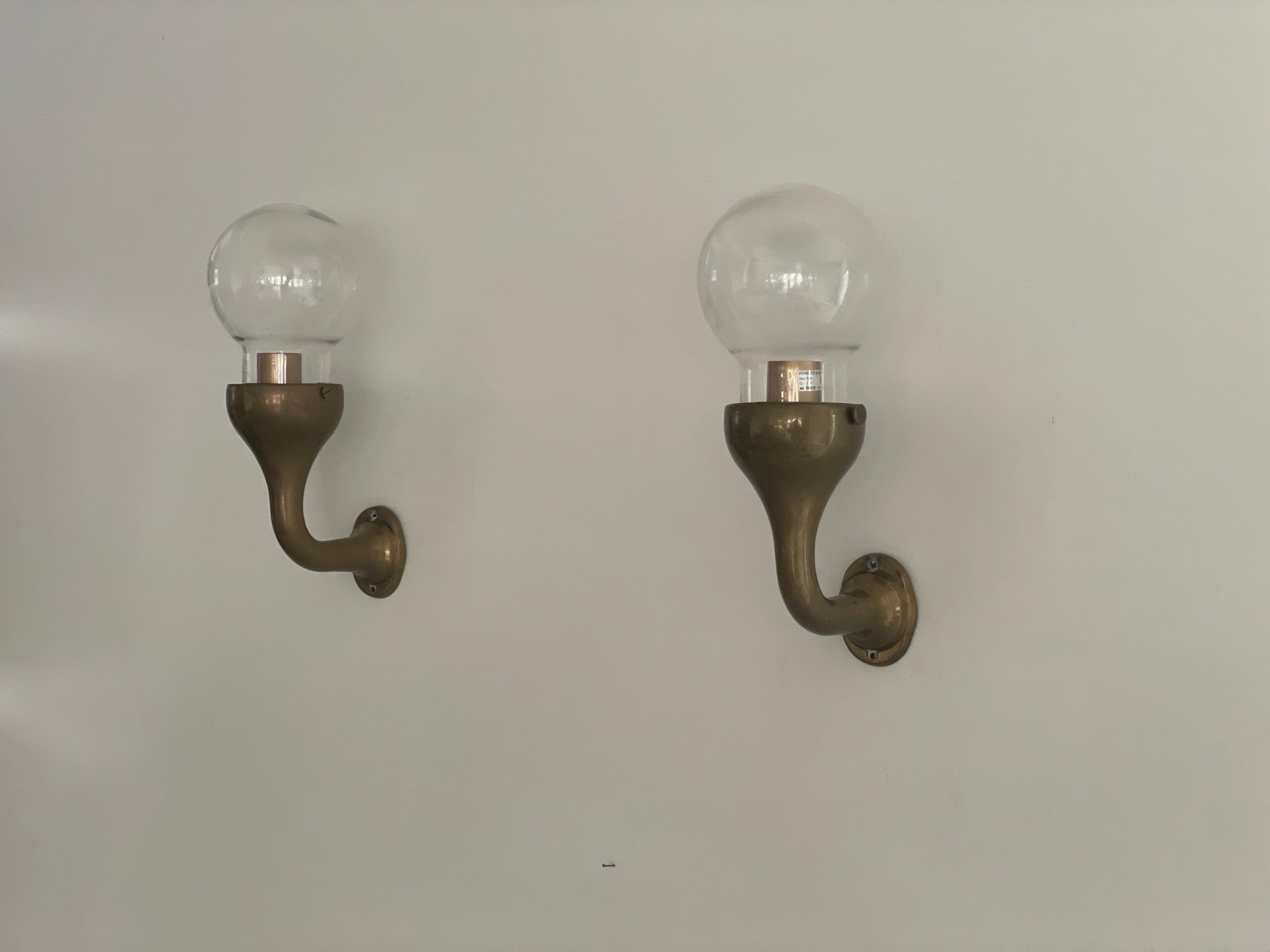 Modernist Glass and Bronze Body Pair of Sconces, 1960s, Italy

Very elegant and Minimalist wall lamps.

Lamps are in excellent condition.

These lamps works with E27 standard light bulbs. 
Wired and suitable to use in all countries. (110-220