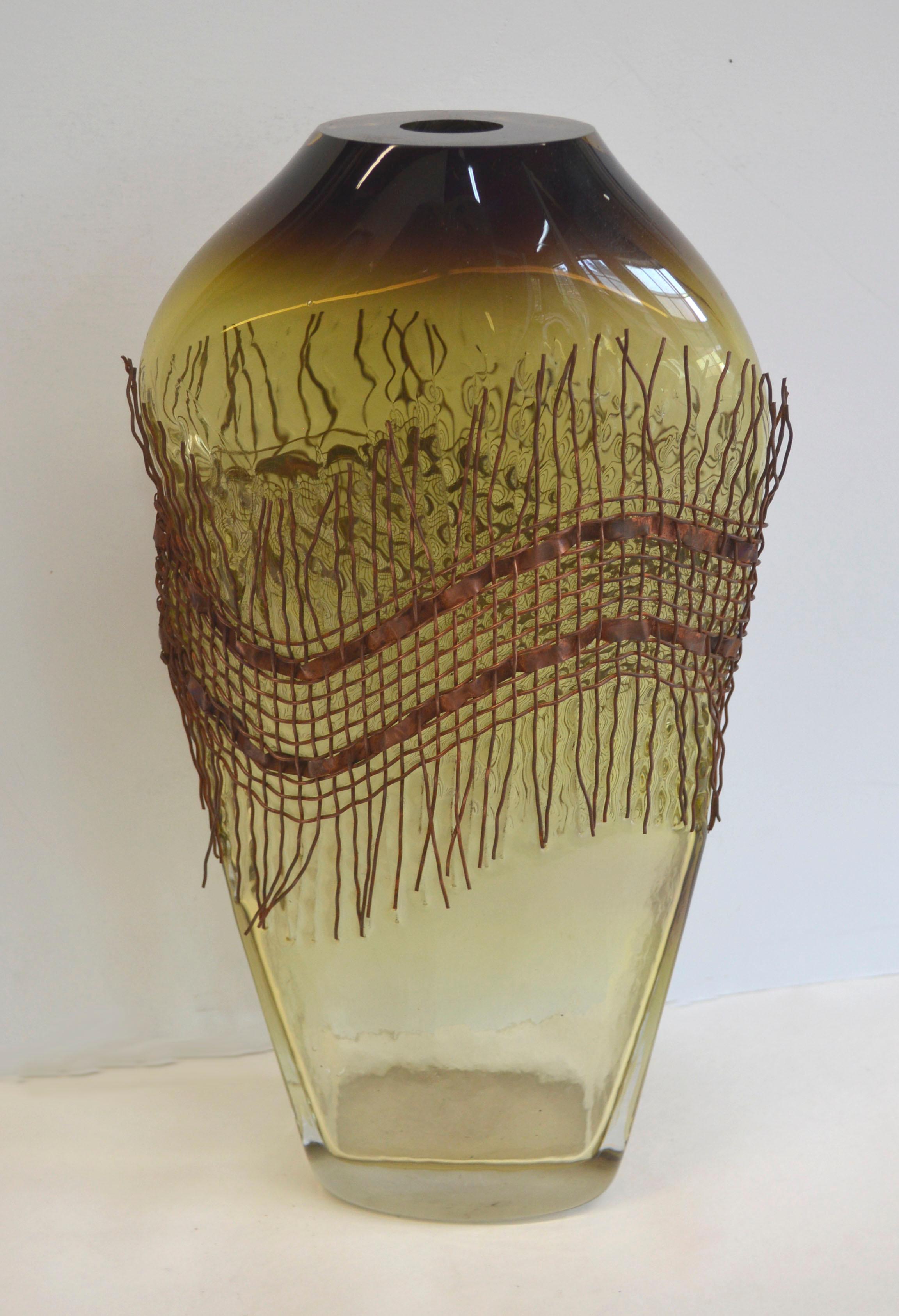 Stunning modernist glass blown vase wrapped in Brutalist style copper woven wire. By Jim and Connie Grant (American, 20th Century), 2005. Etched on bottom 