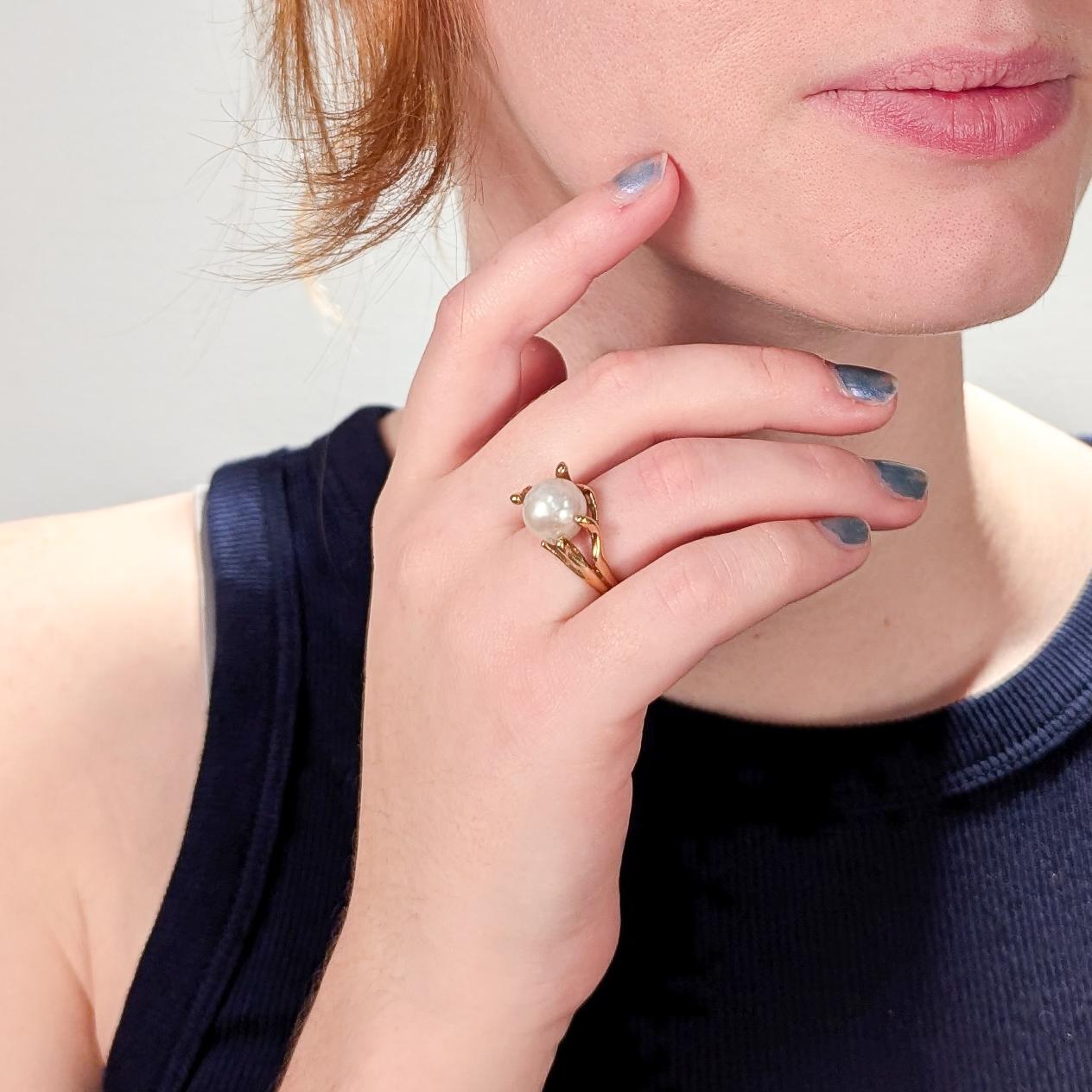 A fine, modernist 14k yellow gold and baroque pearl cocktail ring from the mid-20th century.

Features a large baroque pearl in an organic, pronged setting.

Interior of shank stamped: 14K 

Overall Width: ca. 3/4 in.
Ring size: 6 1/4 
Pearl size: 