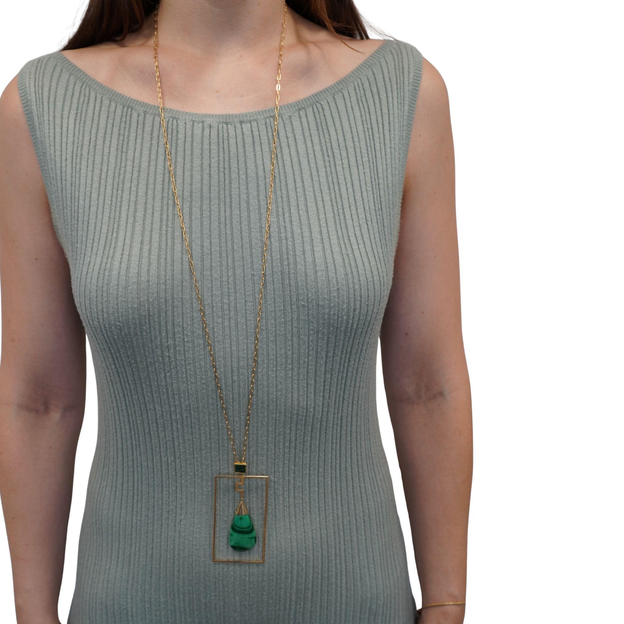This vintage necklace features a bold modernist design with a geometric malachite pendant suspended from a long 14k gold chain. The chain is stamped 14k and measures 39 3/4 inches in length, allowing the pendant to be worn as a dramatic statement