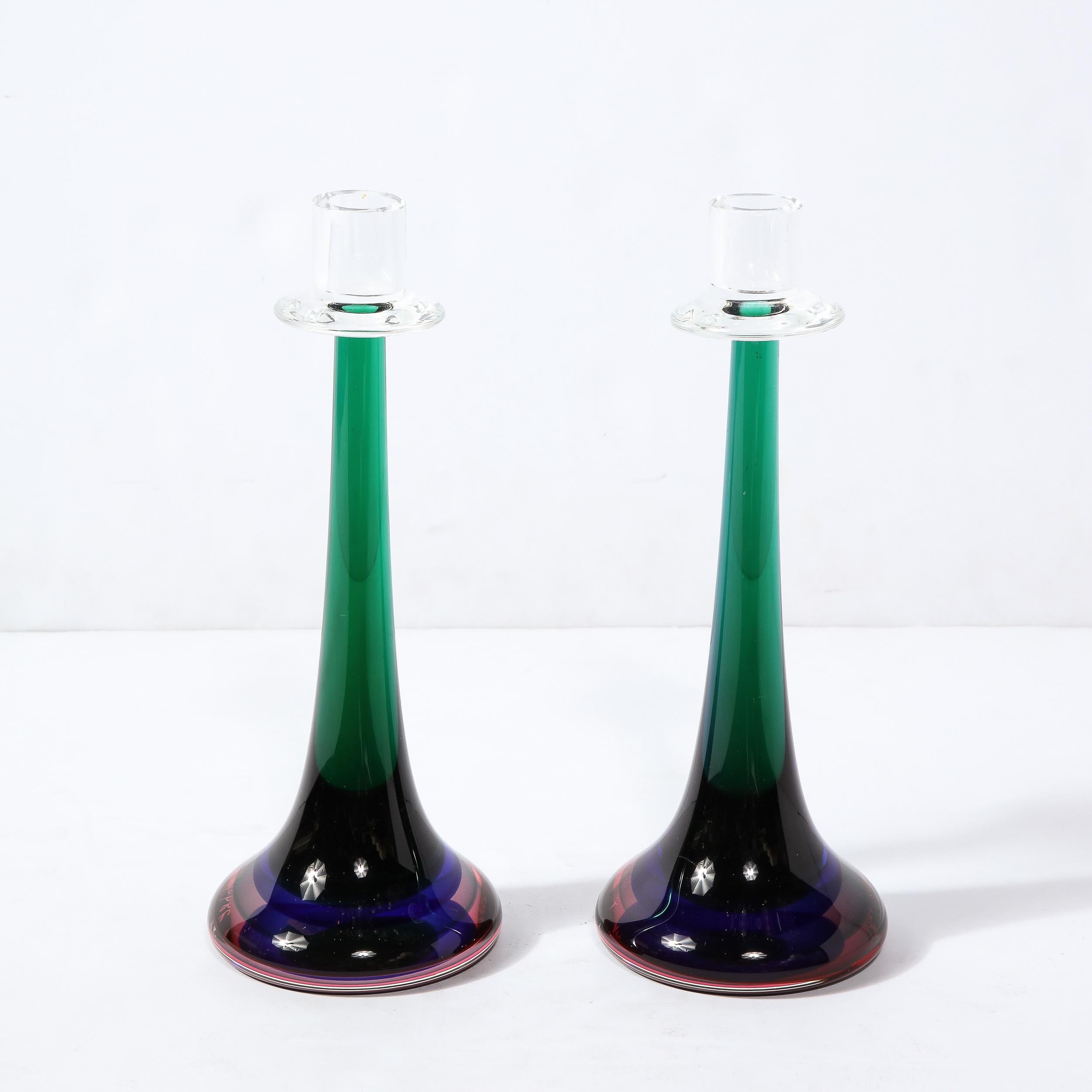 This stunning pair of modernist candlesticks were handblown by the esteemed studio of Signoretti in Murano, Italy- the island off the coast of Venice renowned for centuries for its superlative glass production, circa 2010. They offer conical forms