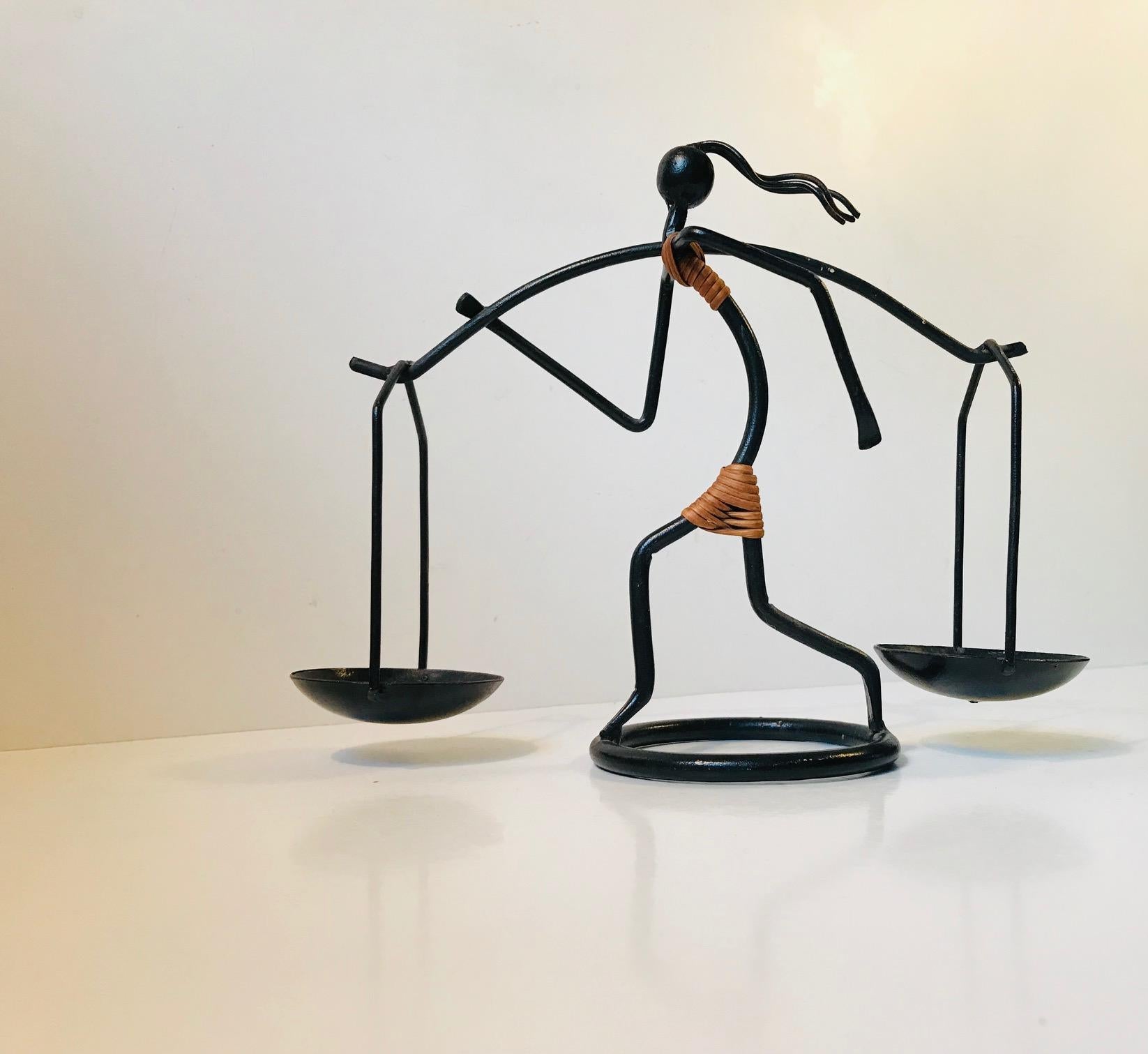 This figurative candleholder for two block or ball candles is made from bend wire-steel with applied rattan detailing. It was designed by Laurids Lønborg and manufactured during the 1960s by LL Design in Denmark.