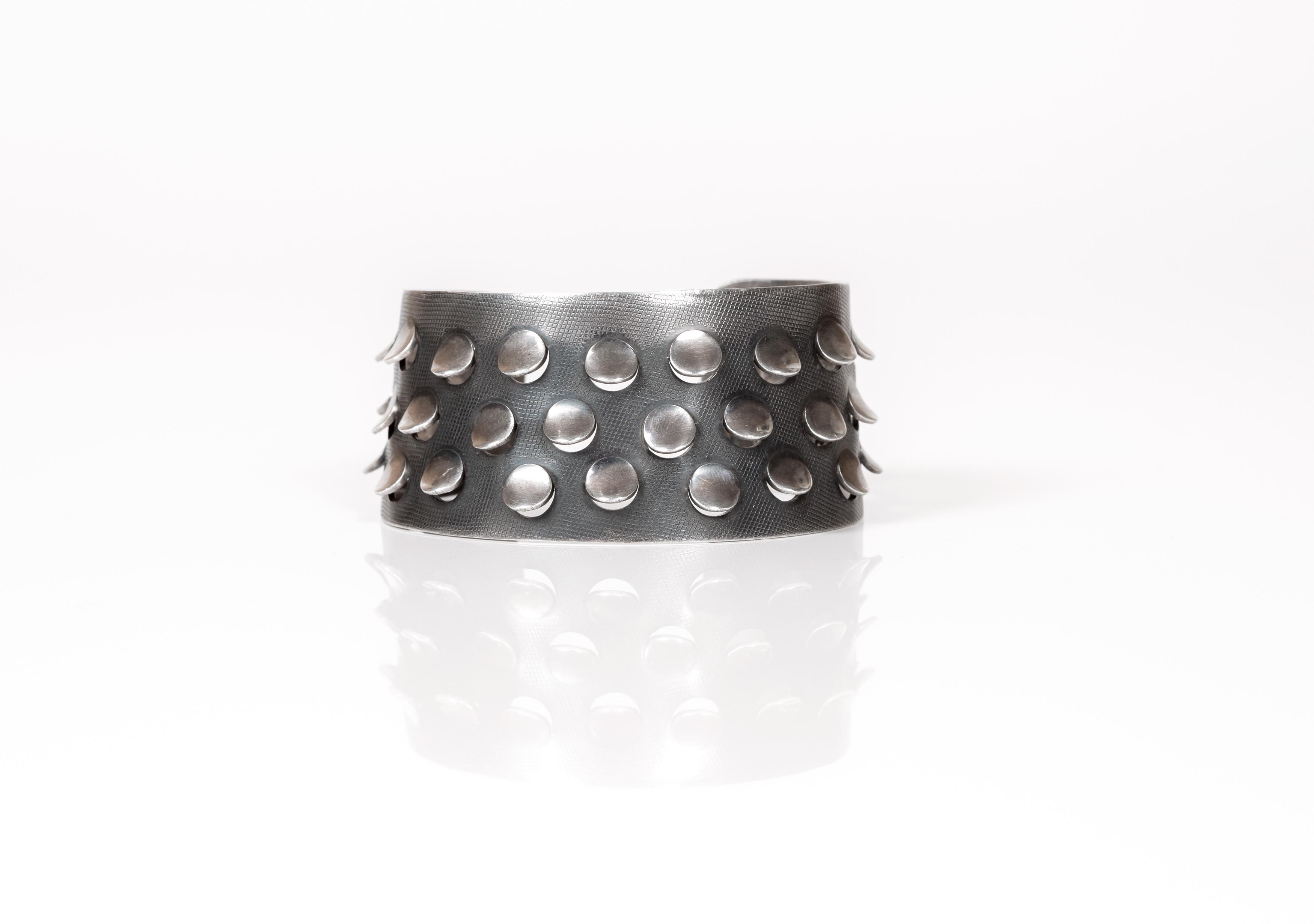 Wonderful and decorative silver bracelet in guilloche pattern, with raised incision points. Designed by Grete Prytz Kittelsen for J. Tostrup from ca 1950s first half. 