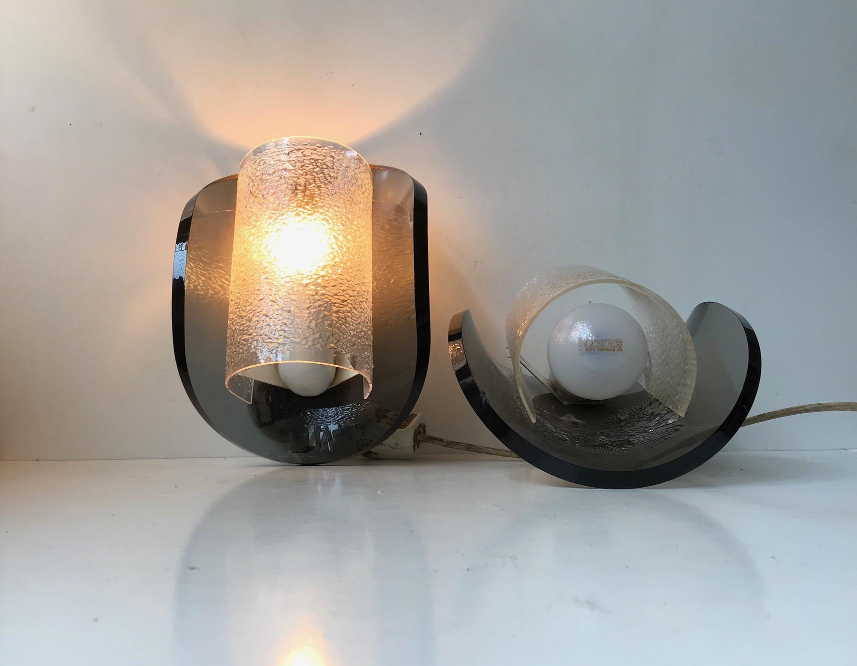 A pair of grey bend Lucite wall lights. Manufactured and sold via Sönnico in Oslo Norway. Anonymous designer in the style of Gino Sarfatti for Arteluce. The lights features original porcelain sockets.