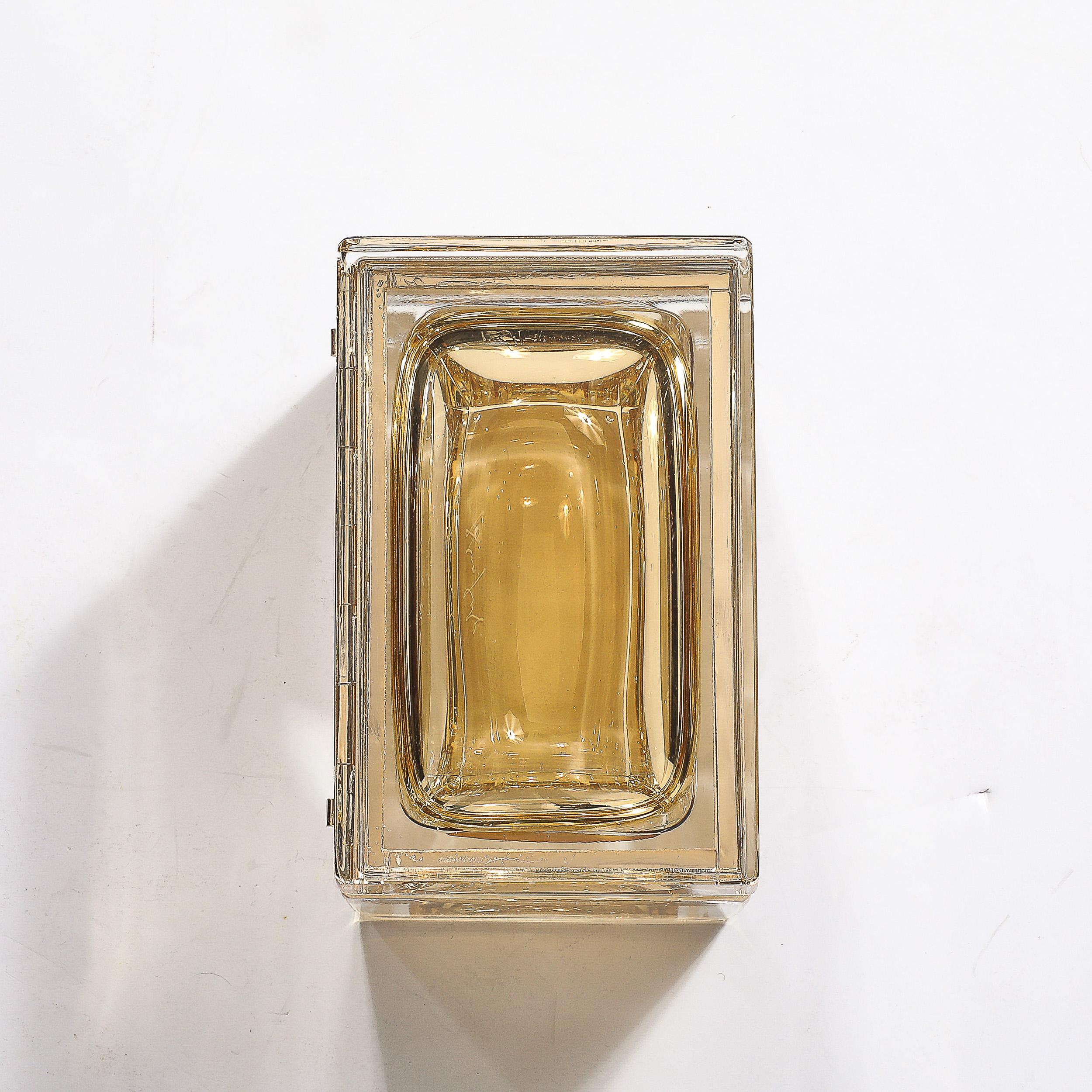 This warm and elegant Modernist Hand-Blown Murano Glass Box in Amber W/ Brass Fittings originates from Italy during the 21st Century. A sleek and minimal piece with incredible hues and materials, formed in hand-blown murano glass, transparent along