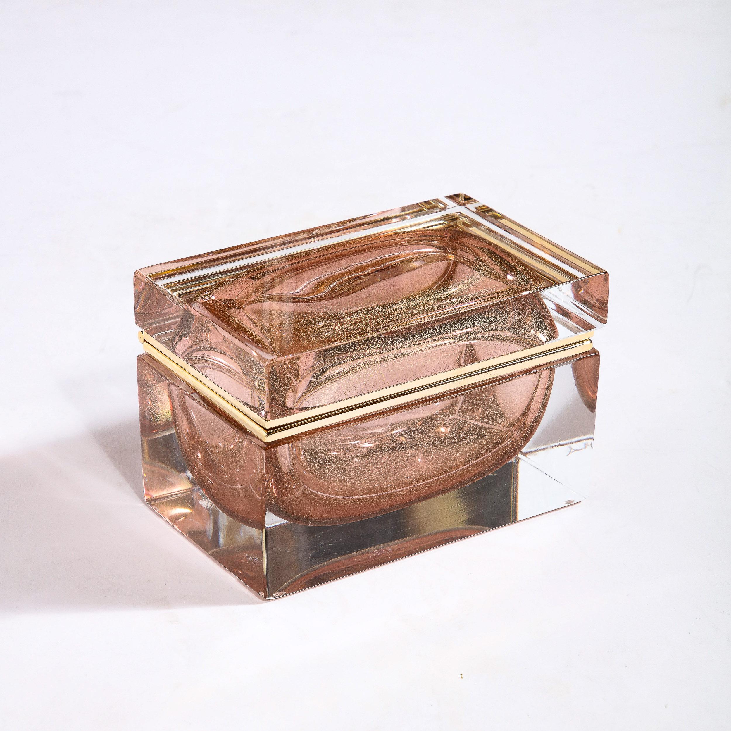 This beautiful modernist decorative box was realized in Murano, Italy- the island off the coast of Venice renowned for centuries for its superlative glass production. It features a volumetric rectangular body with a translucent Murano glass exterior