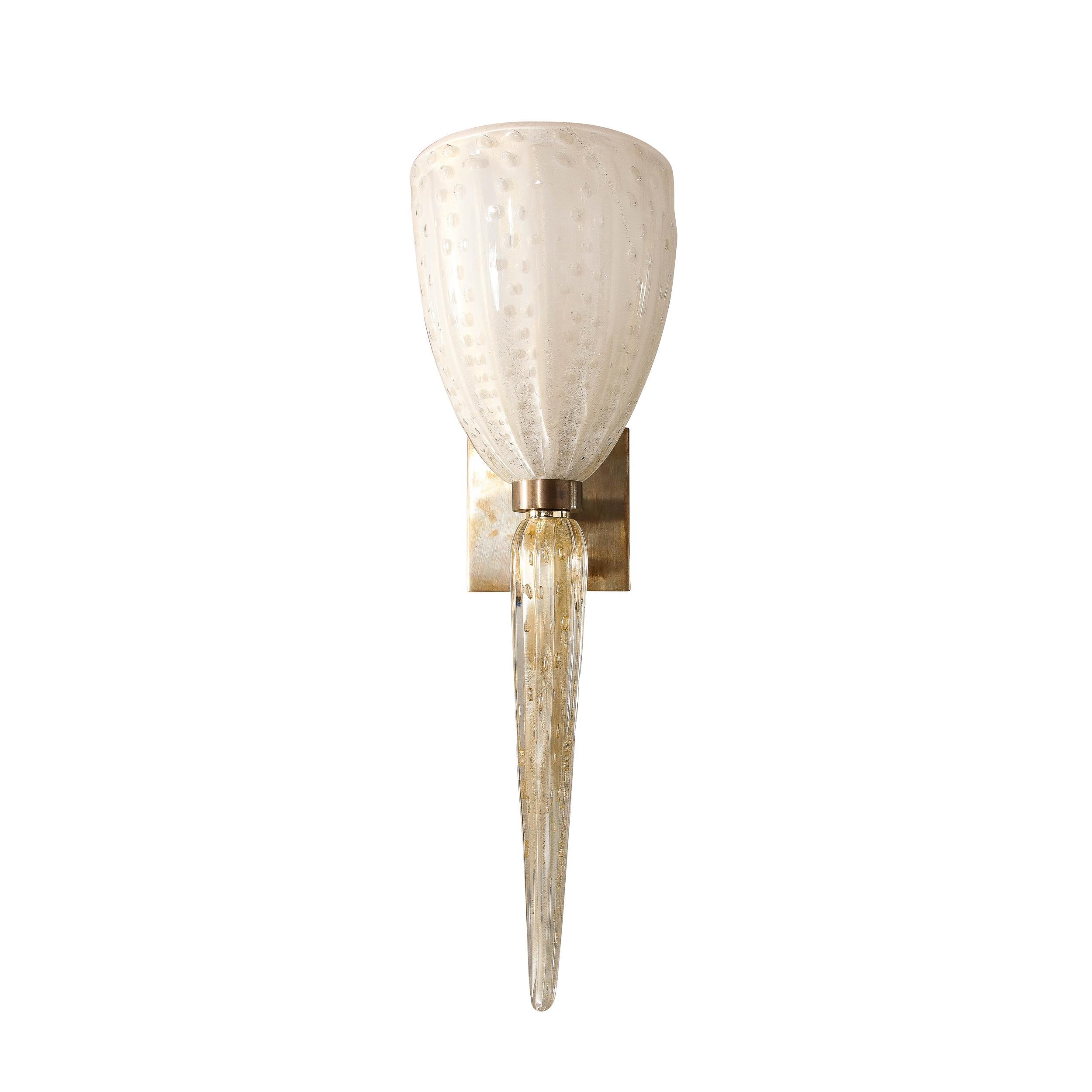 This stunning pair of modernist sconces were realized in Murano, Italy- the island off the coast of Venice renowned for centuries for its superlative glass construction. They feature tapered conical urn form shades in opalescent white Murano glass