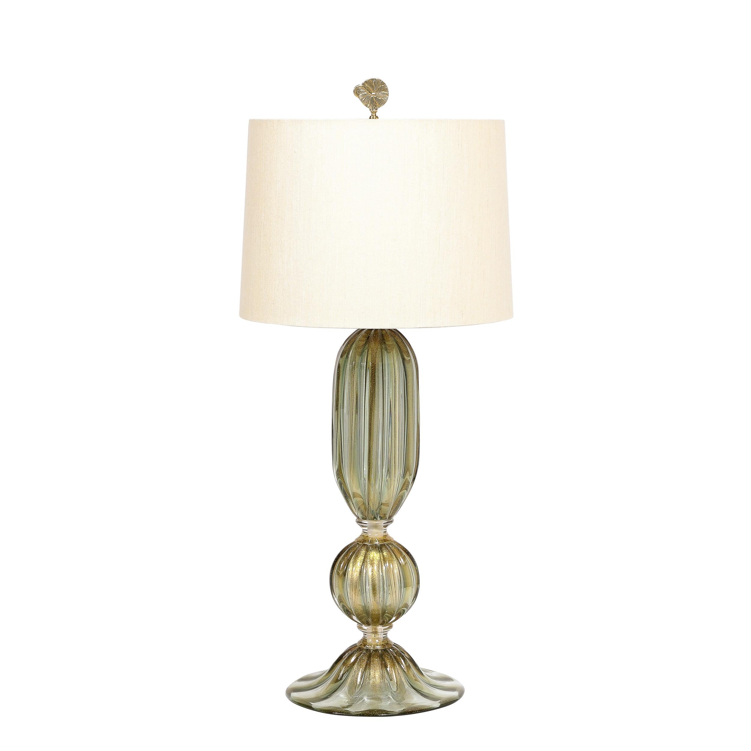 This stunning pair of table lamps were handblown in Murano, Italy- the island off the coast of Venice renowned for centuries for its superlative glass production. They feature undulating bodies in handblown translucent iridescent reeded glass imbued