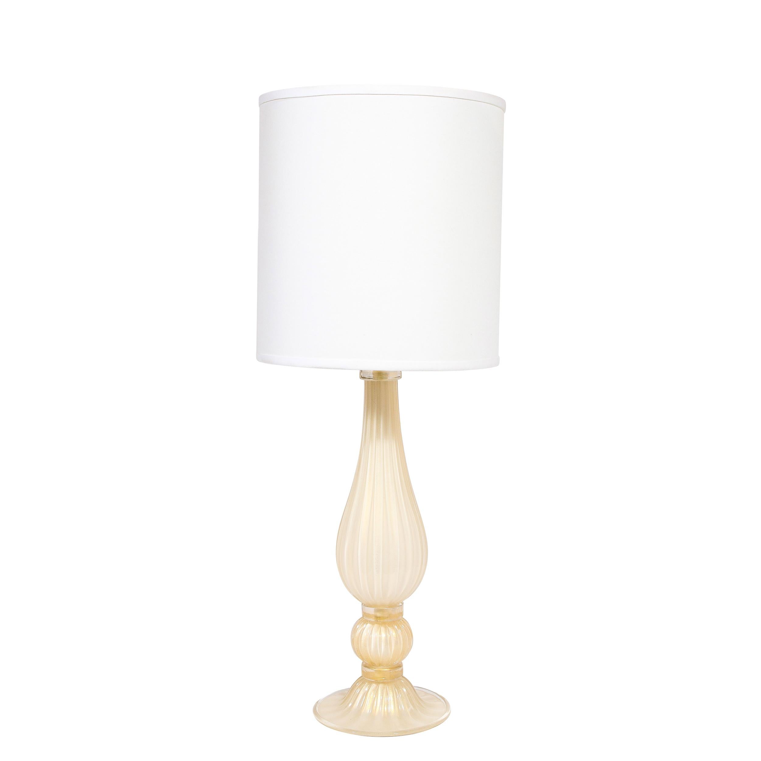 This elegant pair of table lamps were handblown in Murano, Italy- the island off the coast of Venice renowned for centuries for its superlative glass production. They feature tear drop form bodies in handblown translucent reeded glass in a