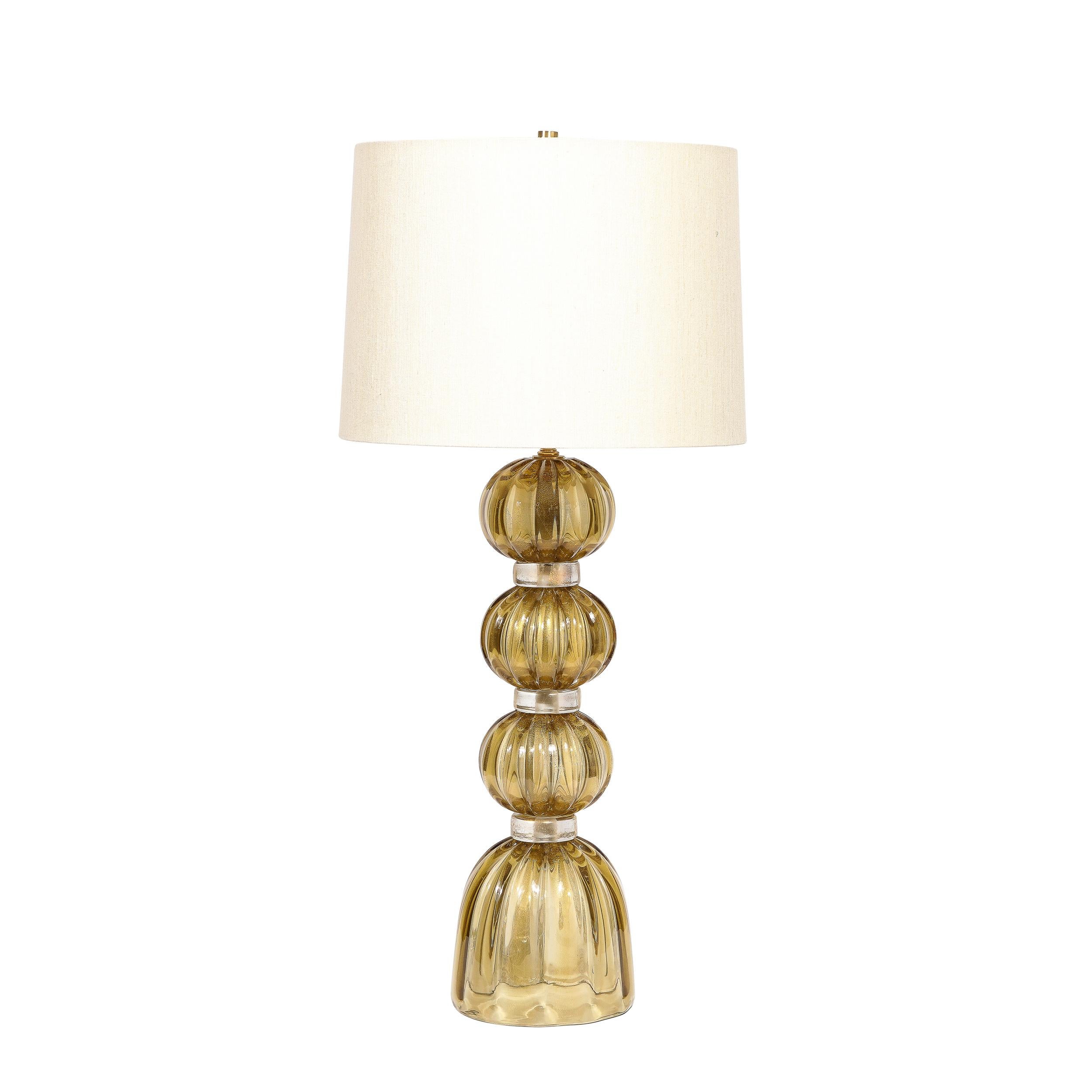 
This beautiful and refined pair of table lamps were handblown in Murano, Italy- the island off the coast of Venice renowned for centuries for its superlative glass production. They sculptural undulating cylindrical bodies in handblown reeded
