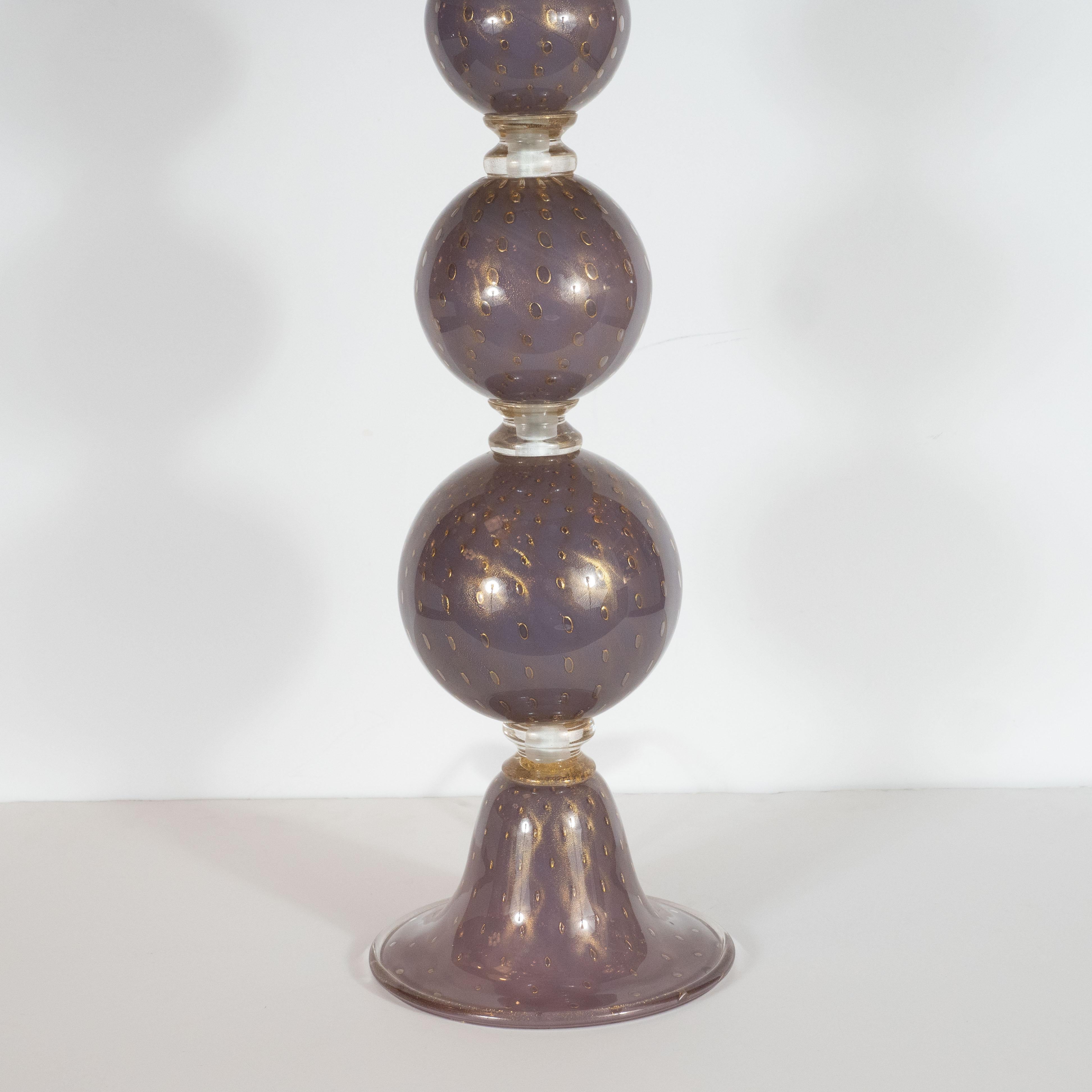 This stunning pair of table lamps were hand blown in Murano, Italy- the island off the coast of Venice renowned for centuries for its superlative glass production. They feature three spherical forms ascending from a conical base with a circular