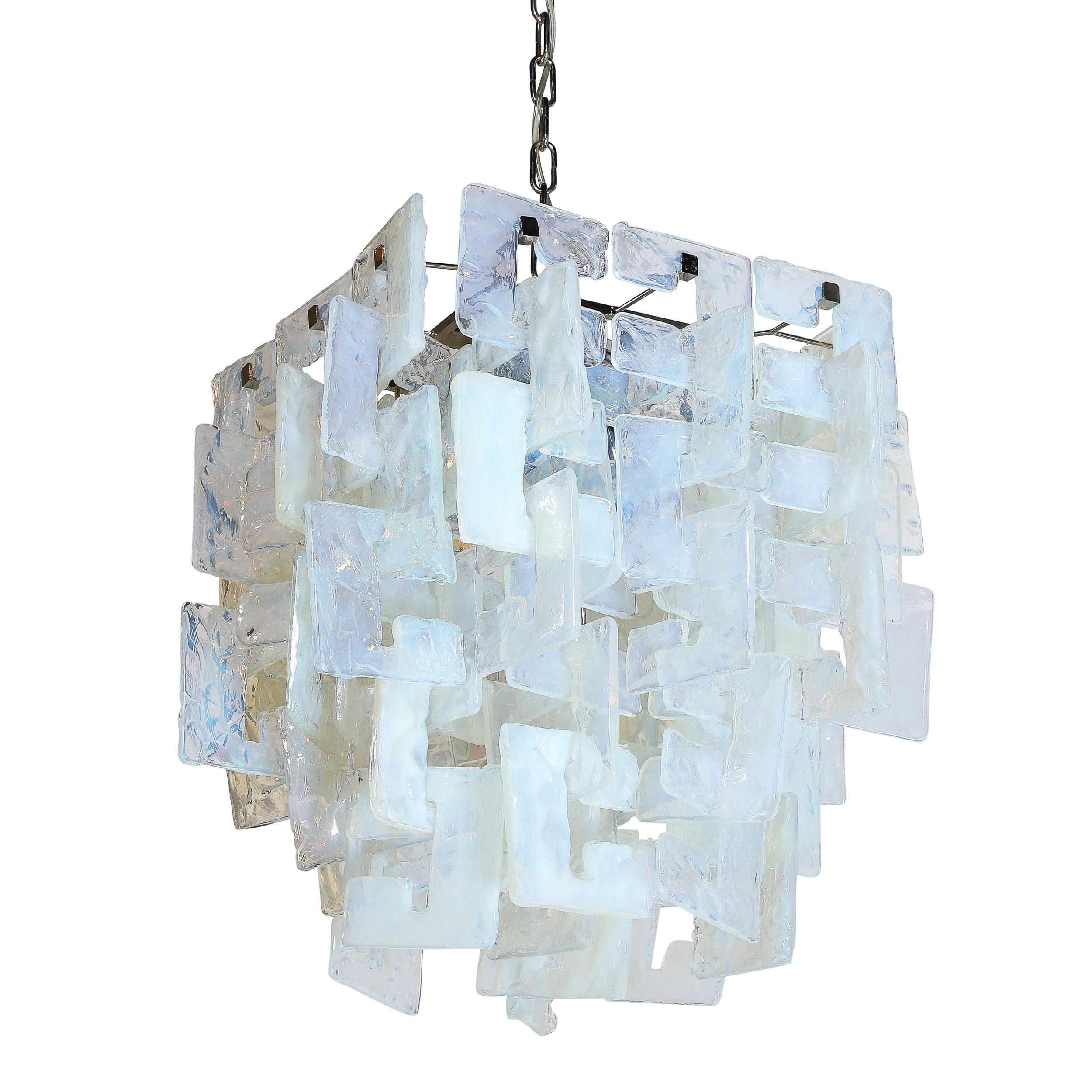 This stunning modernist chandelier was realized in Murano, Italy- the island off the coast of Venice renowned for centuries for its superlative glass production. It features rectangular bodies consisting of an abundance of translucent interlocking