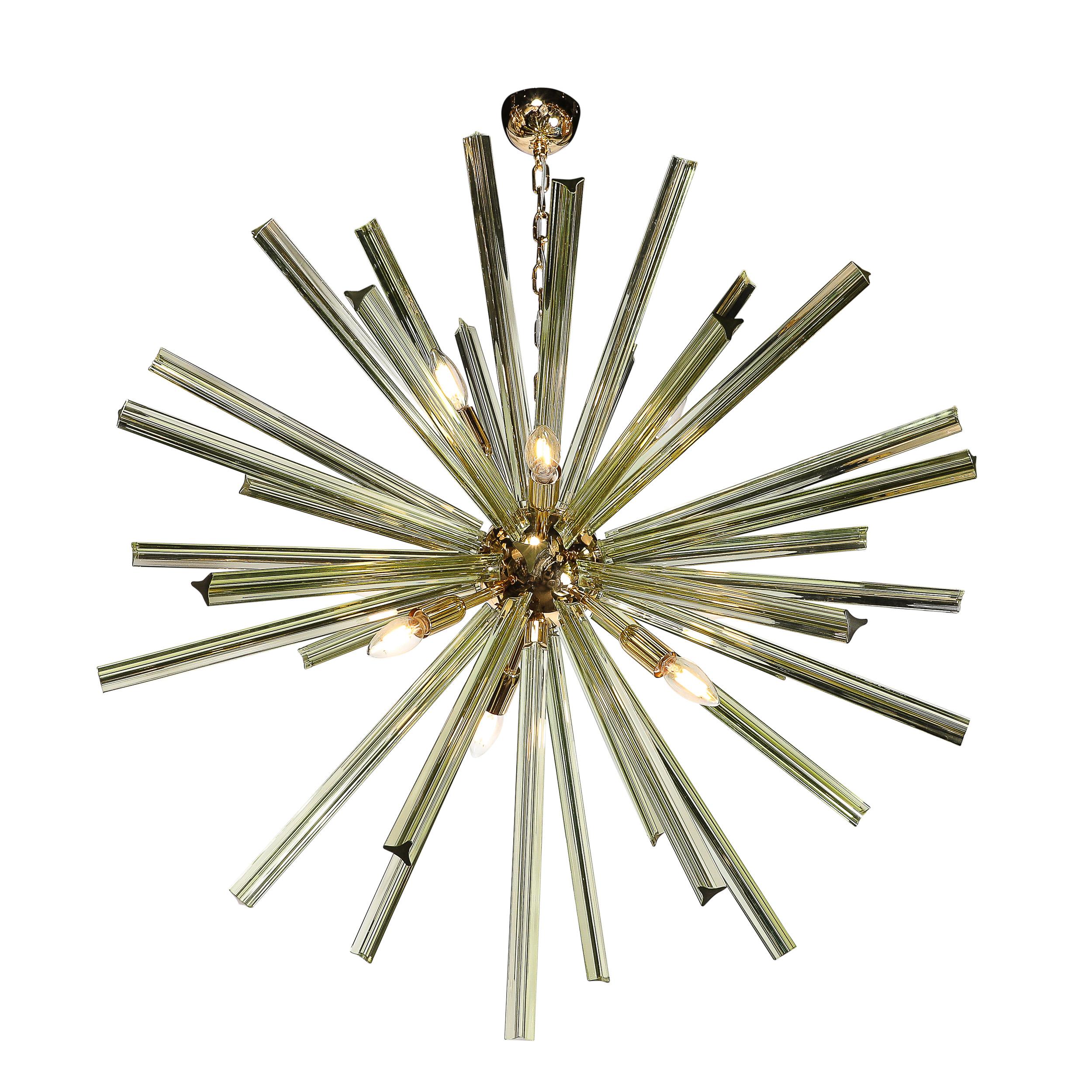 This captivating modernist chandelier is a remarkable fusion of Murano glass artistry and avant-garde design. Inspired by the iconic Sputnik form, the chandelier features hand-blown smoked peridot Camer glass elements radiating outward from a