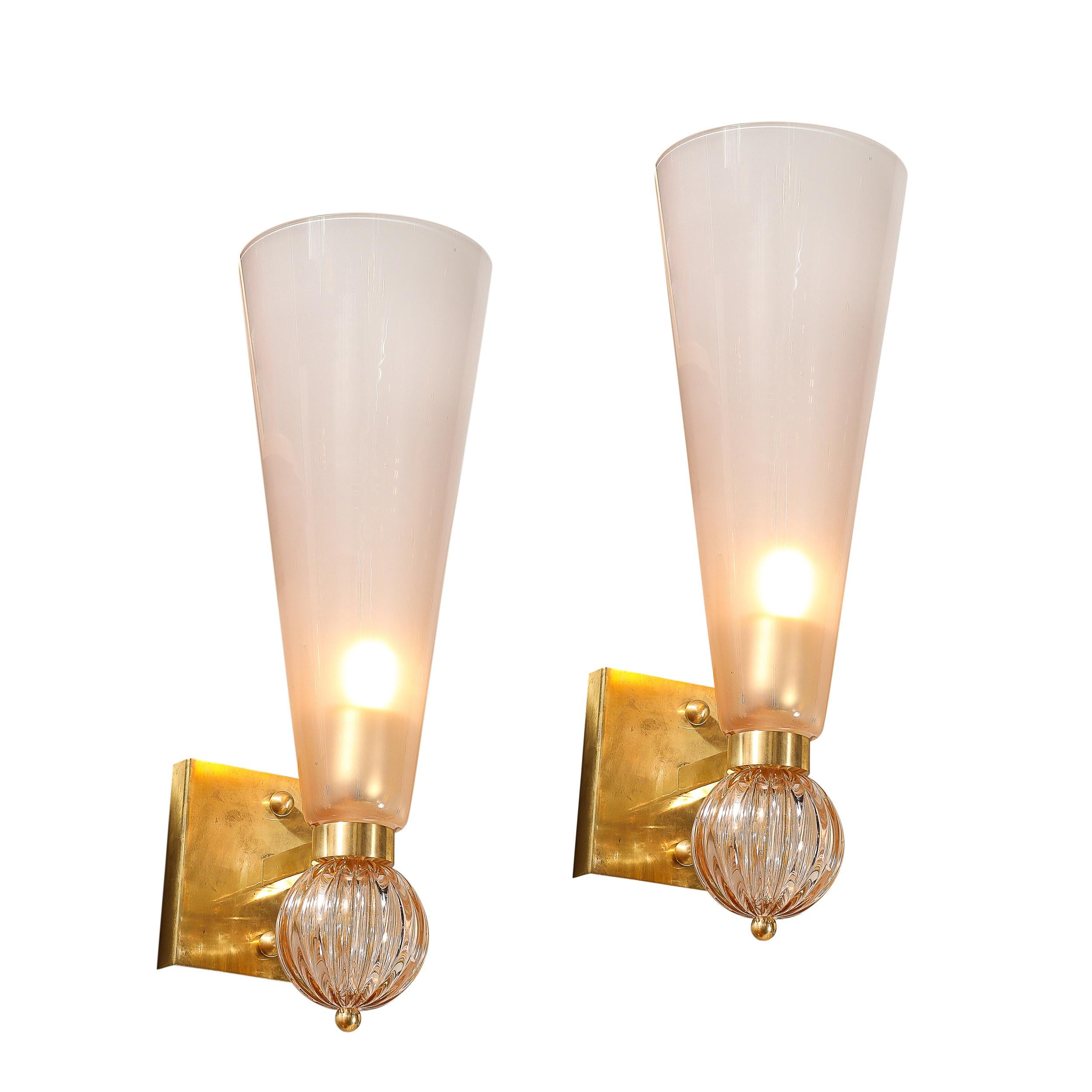 This elegant and powerfully scaled Modernist Hand-Blown Murano Glass Conical Sconces in Smoked Garnet w/ Orbital Drop & Brass Fittings originates from Italy during the 21st Century. Features a tall conical shade with a brass ring delineating the