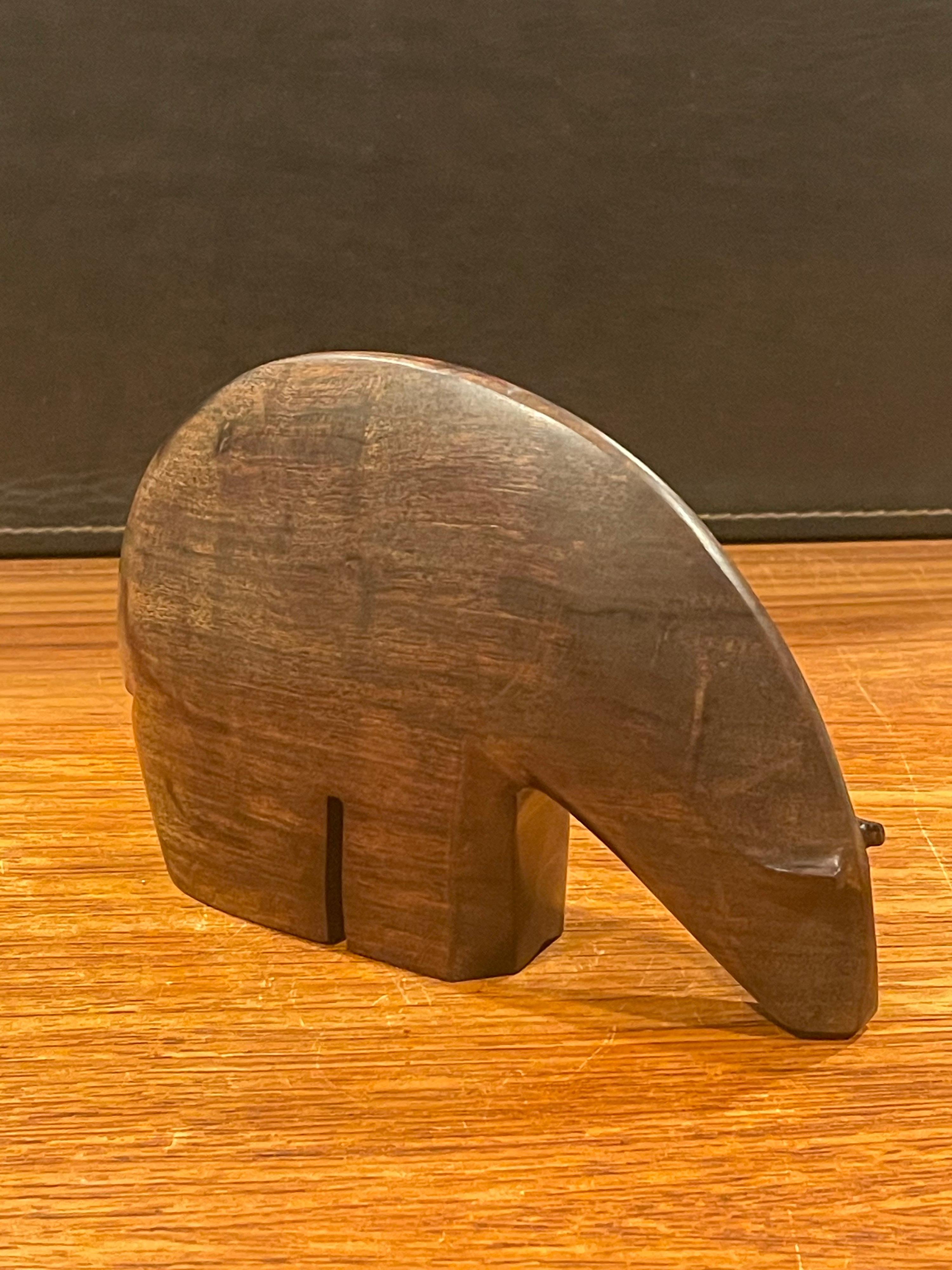 A very cool modernist hand carved rosewood polar bear sculpture in the style of Arne Tjomsland, circa 1960s. This hard to finf MCM piece is in very good vintage condition and measures a 6.75