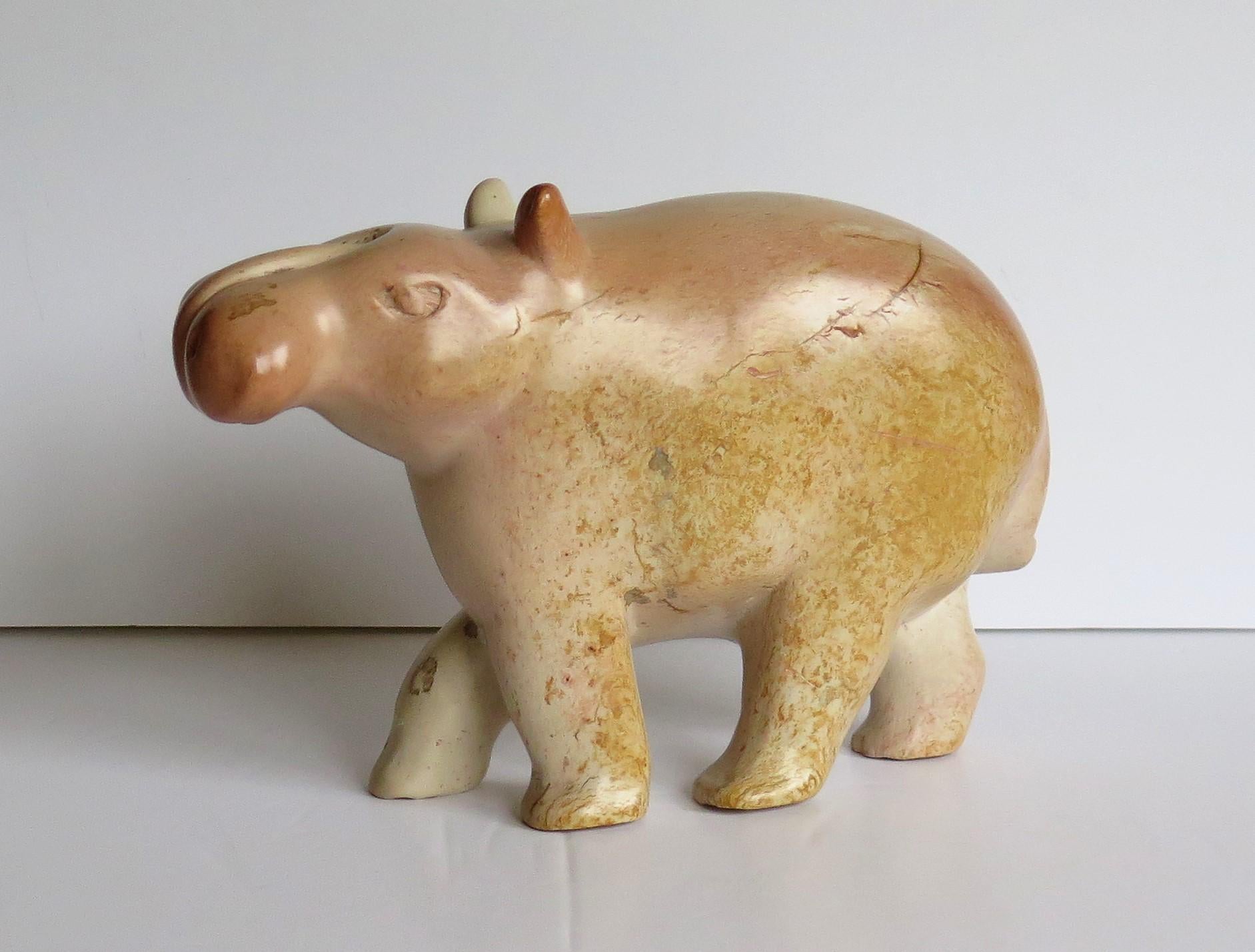 This is an unusual hand carved natural stone, modernist Folk Art, model of a hippopotamus or hippo, which we date to the mid-20th century.

The 