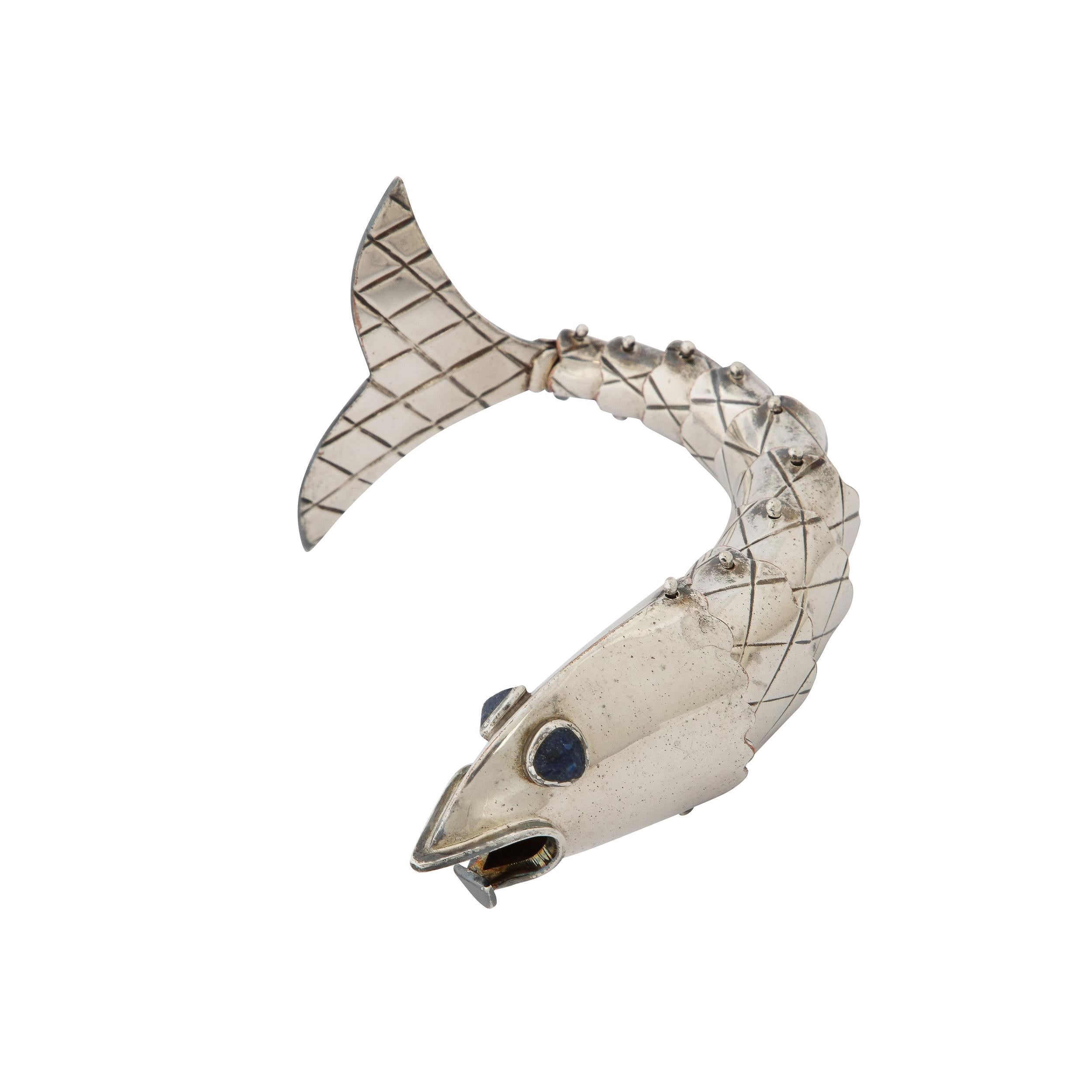 This sophisticated bottle opener was realized by the esteemed modernist design Emilia Castillo in Mexico circa 1980. It offers a stylized interpretation of a small schoolfish (such as a sardine) rendered in a whimsical, yet highly refined manner.