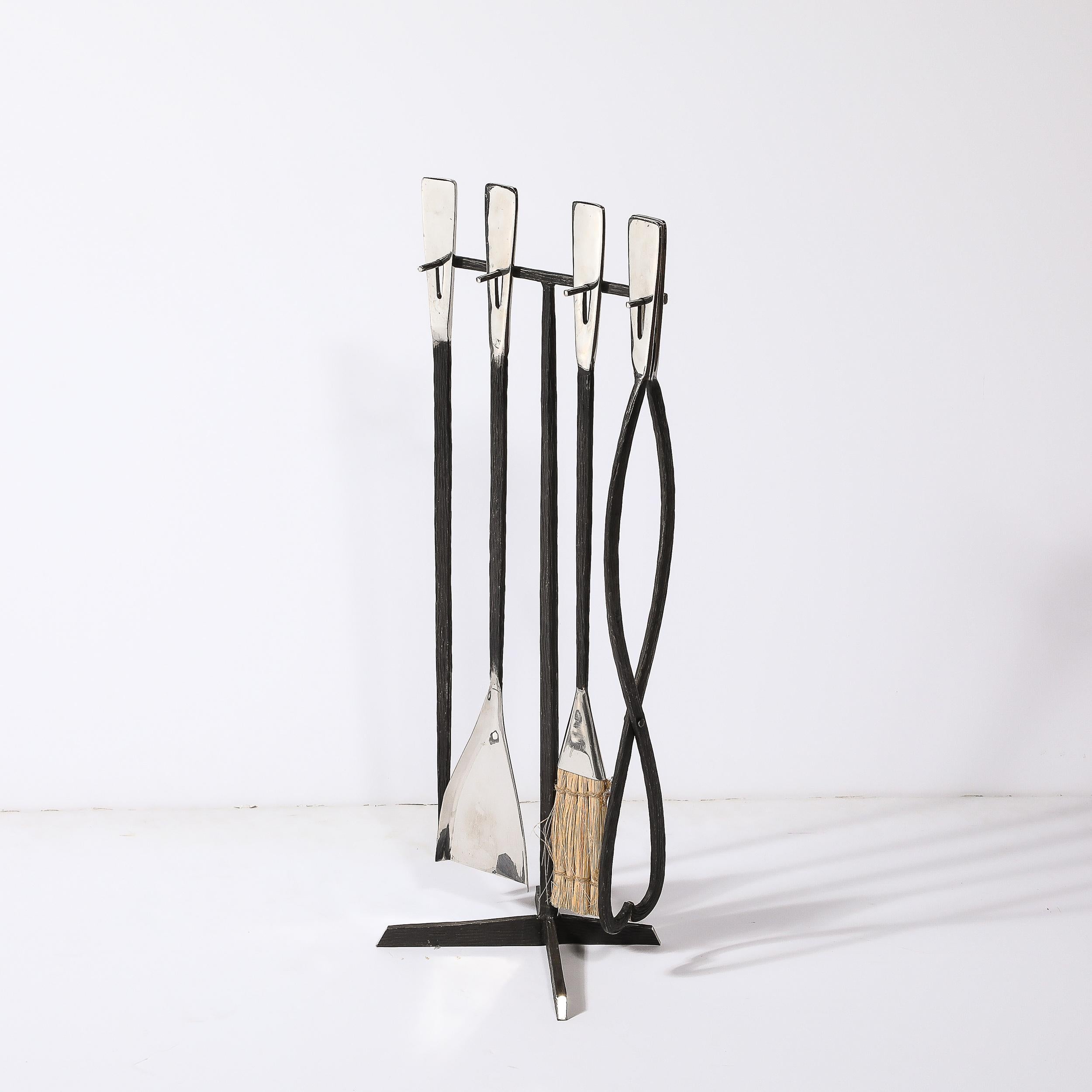 This unique and beautifully formed Modernist Hand-Forged Faux Bois Fire Tool Set in Wrought & Polished Iron originates from the United States during the latter half of the 20th Century. Featuring a minimal framework in wrought iron resting on an