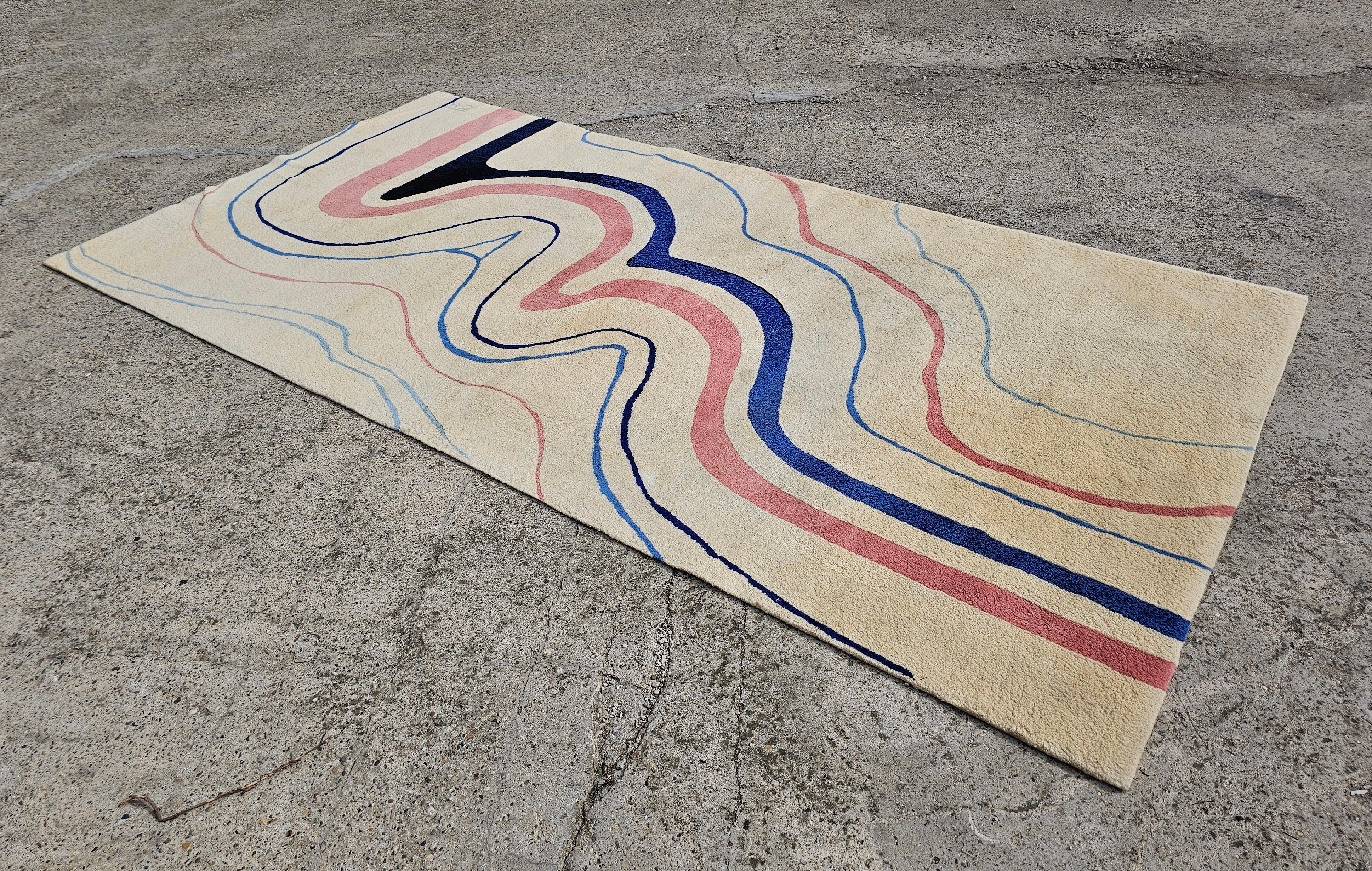 In this listing you will find a Unique Mid Century Modern Rug with abstract pattern. Rug is Hand tufted and it features, creme base, with abstract lines in powder pink and black and blue. One of a kind, with a certificate stating the name of the