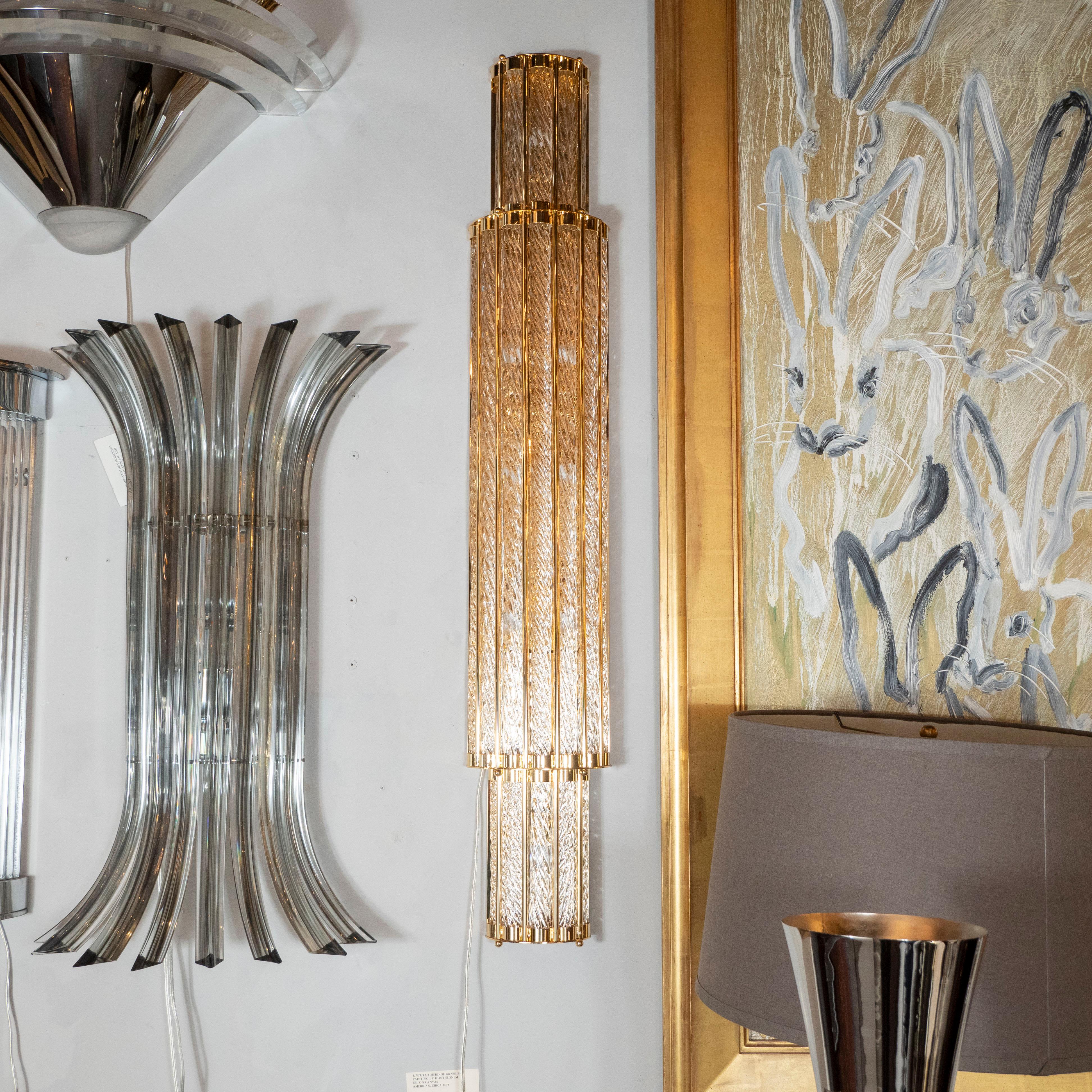 This stunning pair of modernist sconces were handblown in Murano, Italy- the island off the coast of Venice renowned for centuries for its superlative glass production- by our exclusive atelier. They feature skyscraper style convex bodies consisting