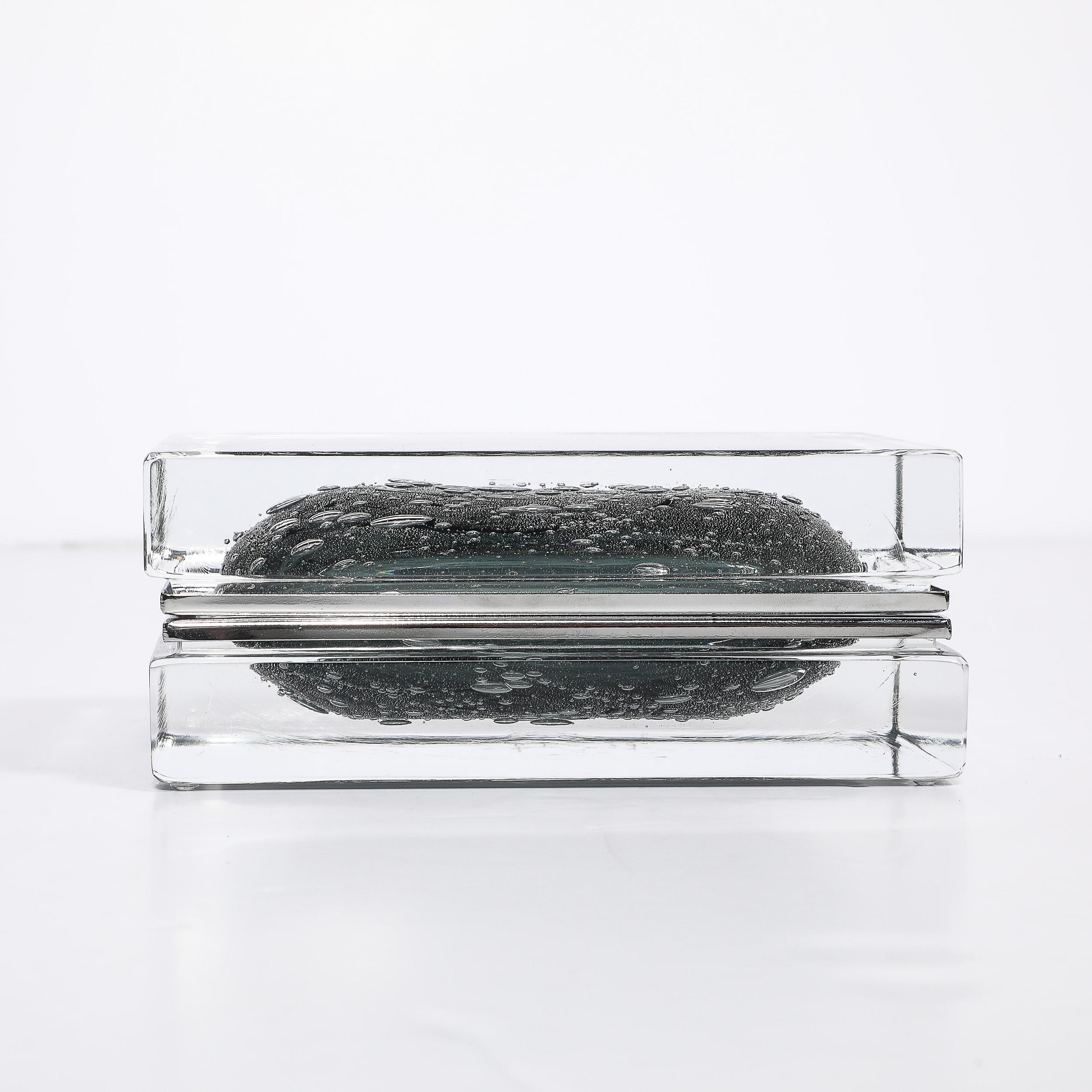This Modernist Hand-Blown Murano Glass Box in Sage Grey is a stunning example of Venetian glass artistry, blending timeless craftsmanship with modernist sensibilities. Handmade in Murano, Italy, by skilled artisans, this piece showcases the mastery