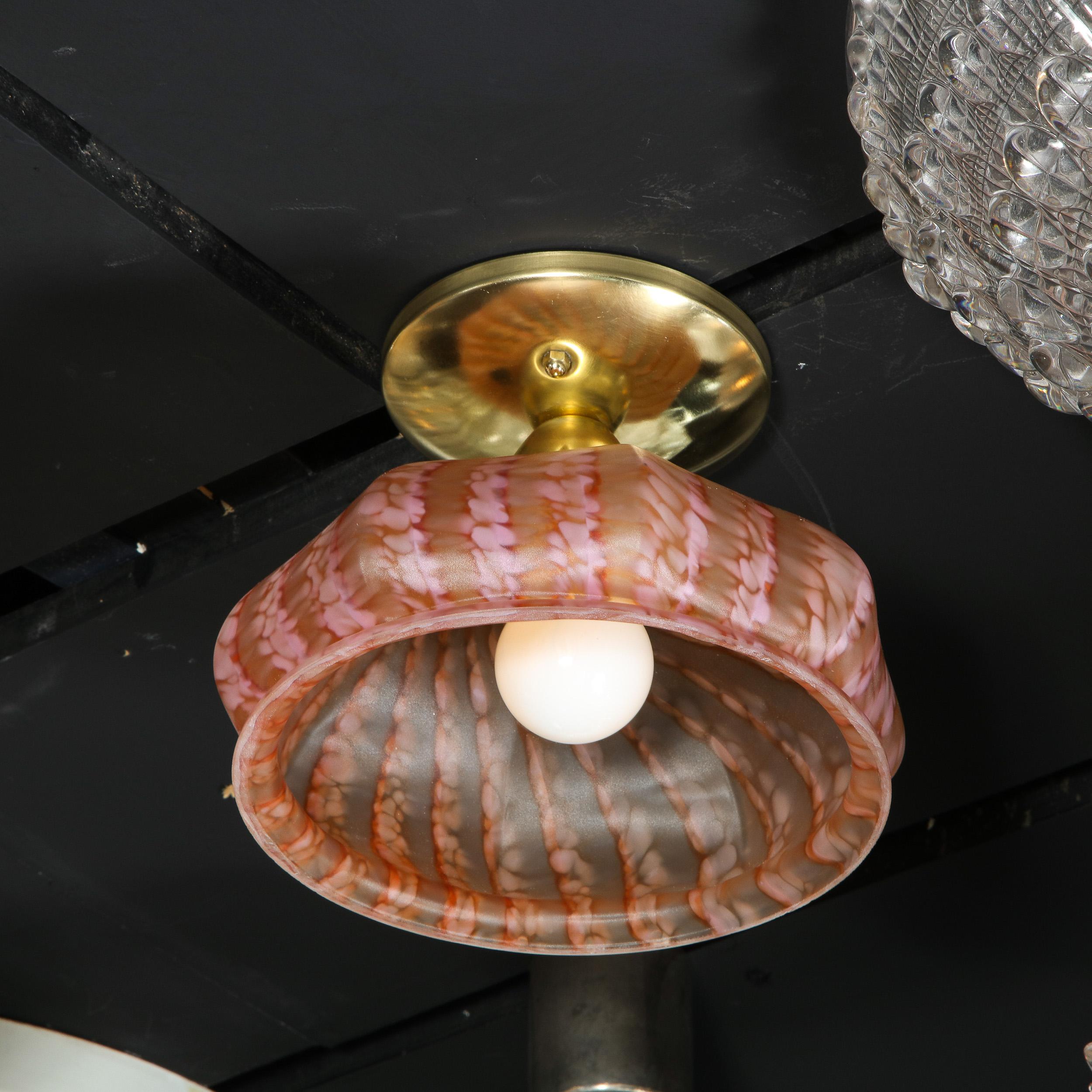 This refined modernist flush mount was realized in Murano, Italy- the island off the coast of Venice renowned for centuries for its superlative glass production- during the 20th century. It features a billowing convex shade in mottled striated