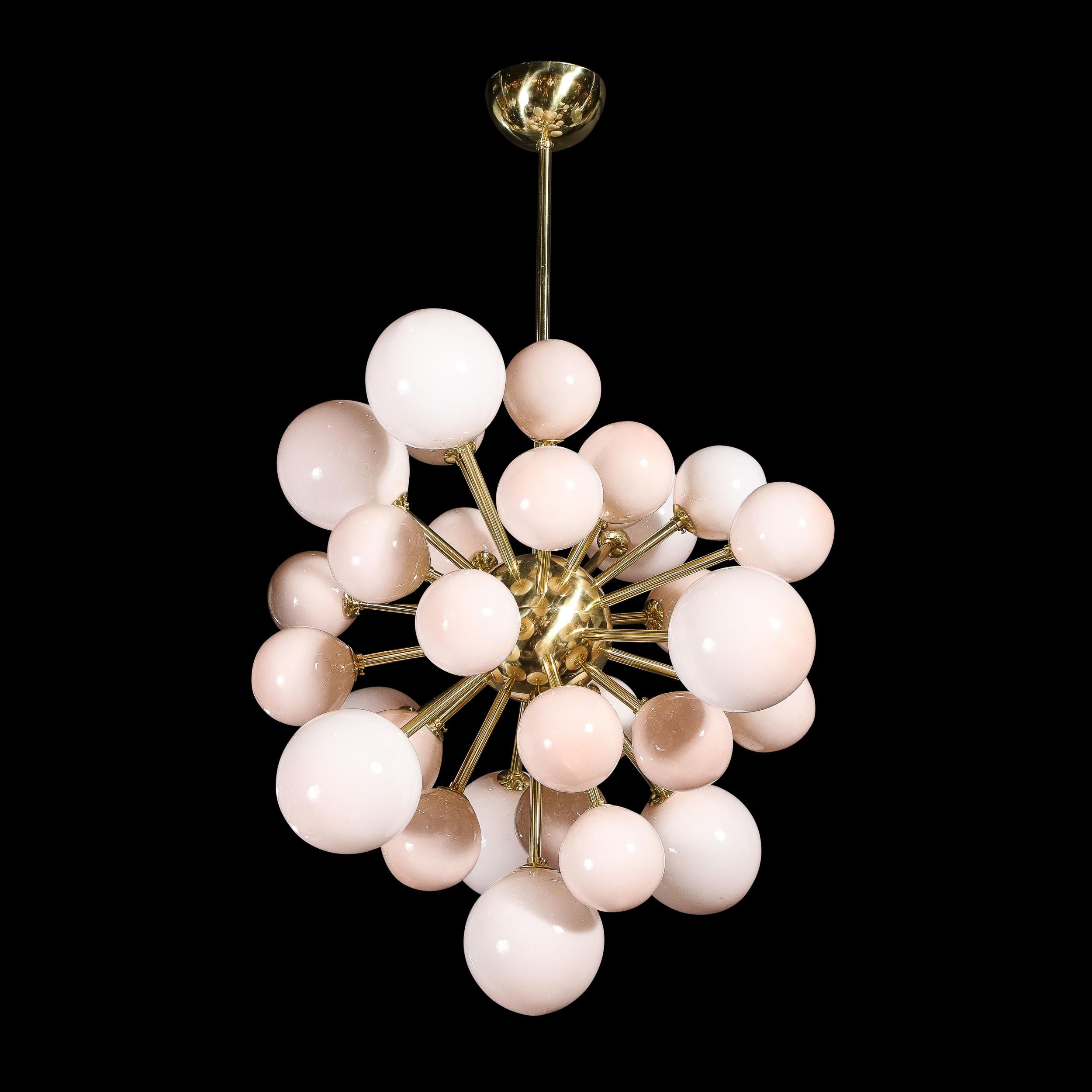 This captivating and graphic modernist sputnik chandelier was handblown in Murano, Italy- the island off the coast of Venice renowned for centuries for its superlative glass production. It features an abundance of orbs in handblown Murano glass of a