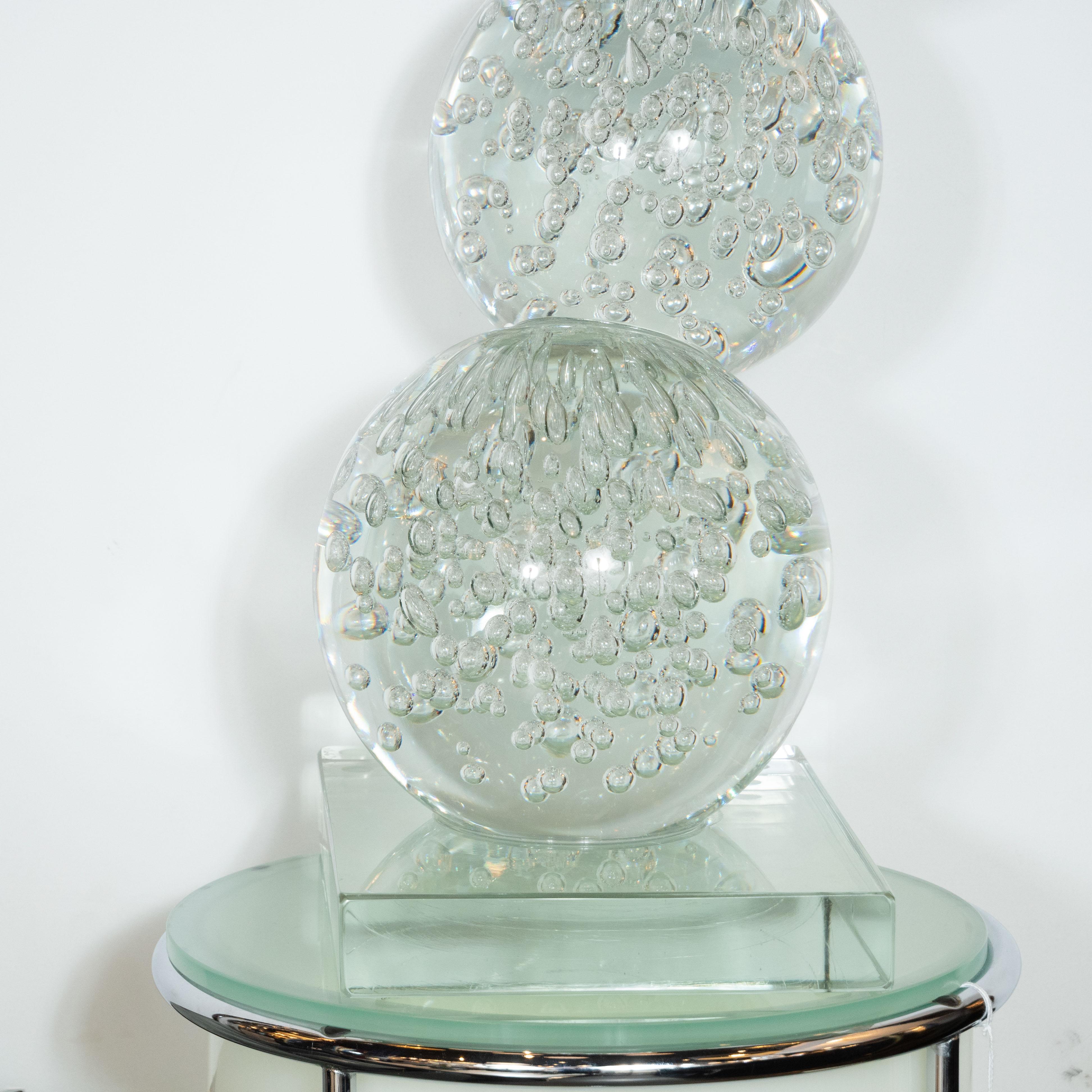 This sophisticated modernist sculpture was hand blown in Murano, Italy- the island off the coast of Venice renowned for its superlative glass production- exclusively for High Style Deco. It features five stacked translucent spherical forms that