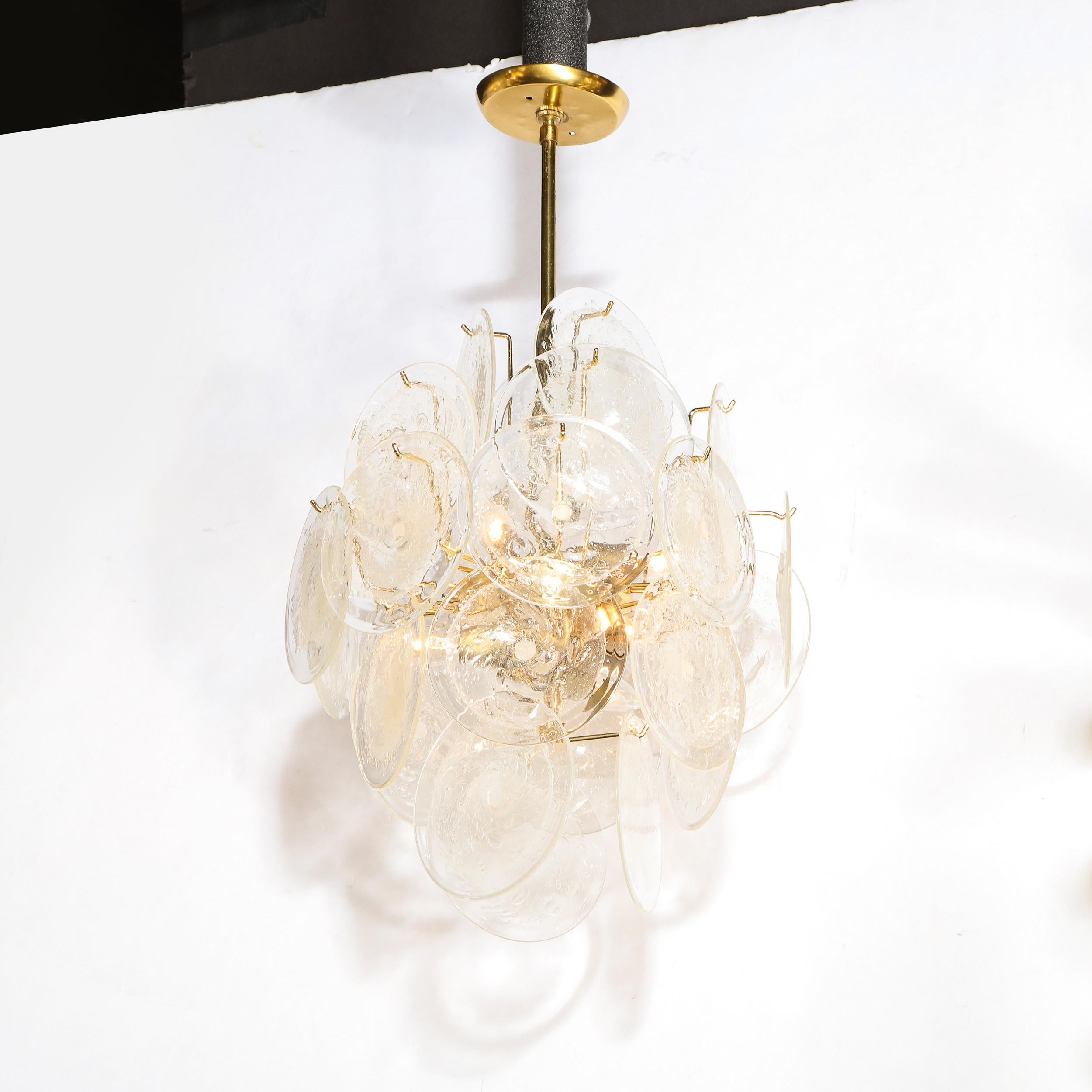 This stunning modernist chandelier was handblown in Murano, Italy- the island off the coast of Venice renowned for centuries for its superlative glass production. It features a wealth of translucent discs with an organic texture, creating a subtle
