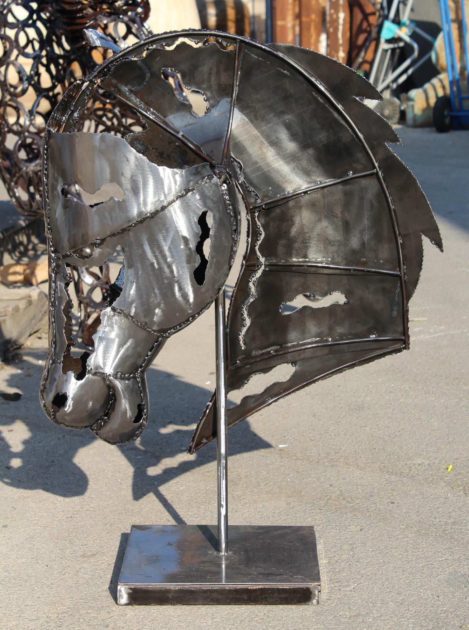 Modernist handcrafted iron horse head sculpture in a polished shiny finish.

    
